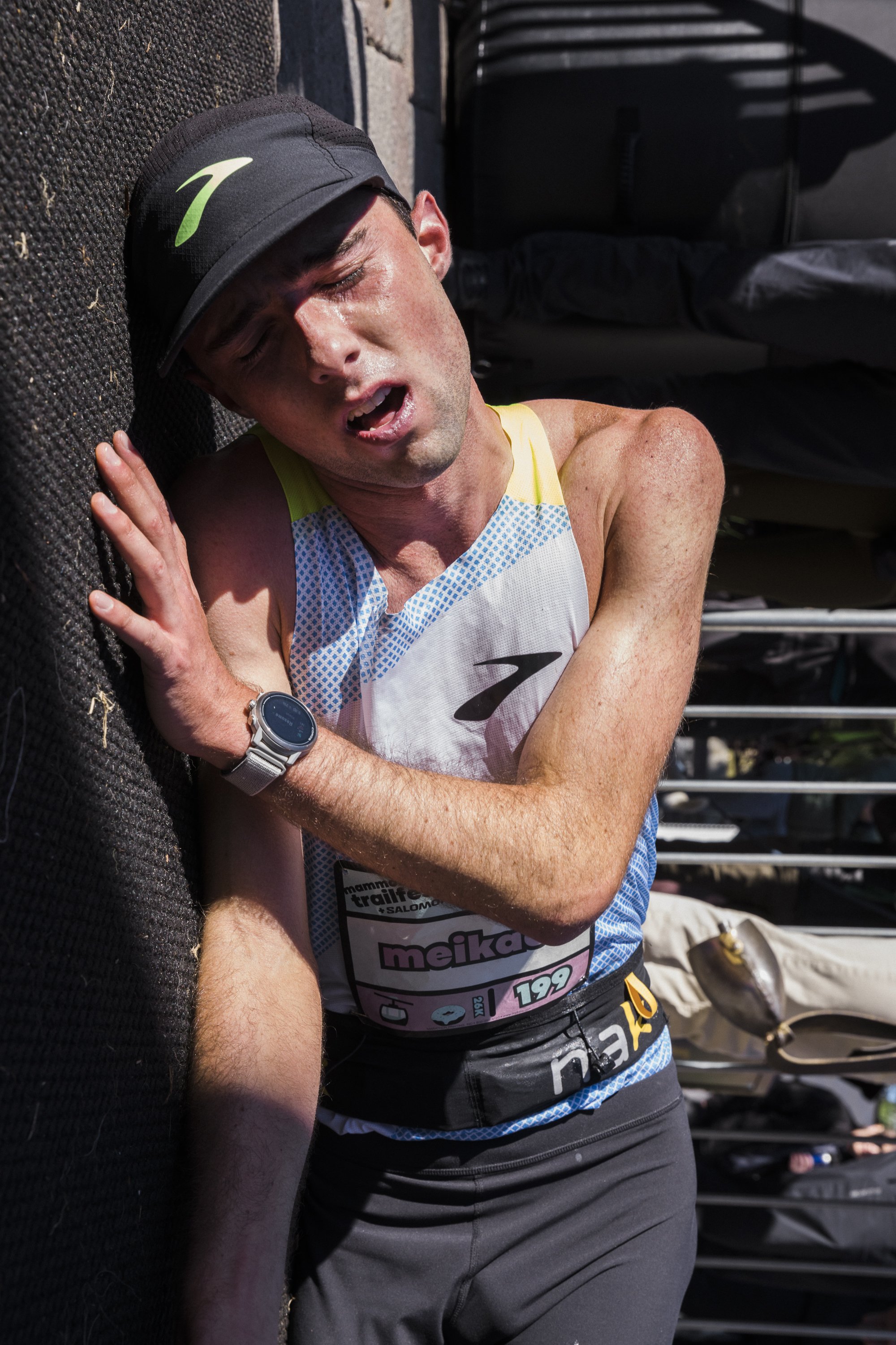 A male runner lies on the ground exhausted at the end of mammoth trail fest