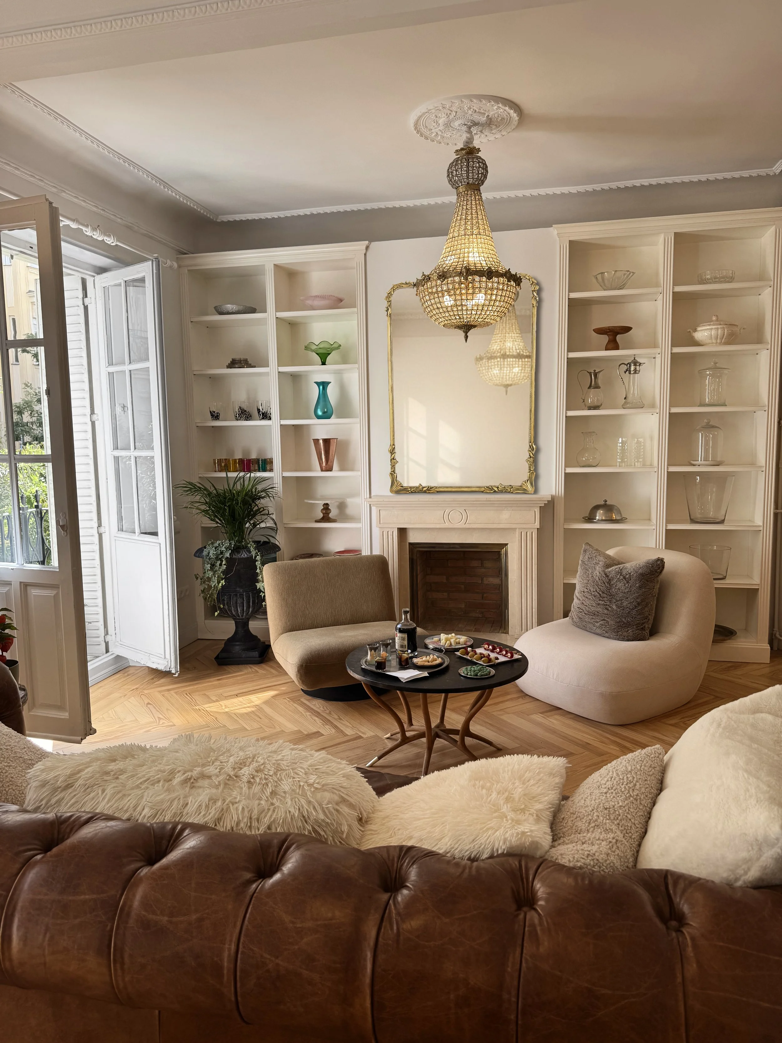 Parisian-style living room with vintage crystal chandelier and ornate ceiling medallion