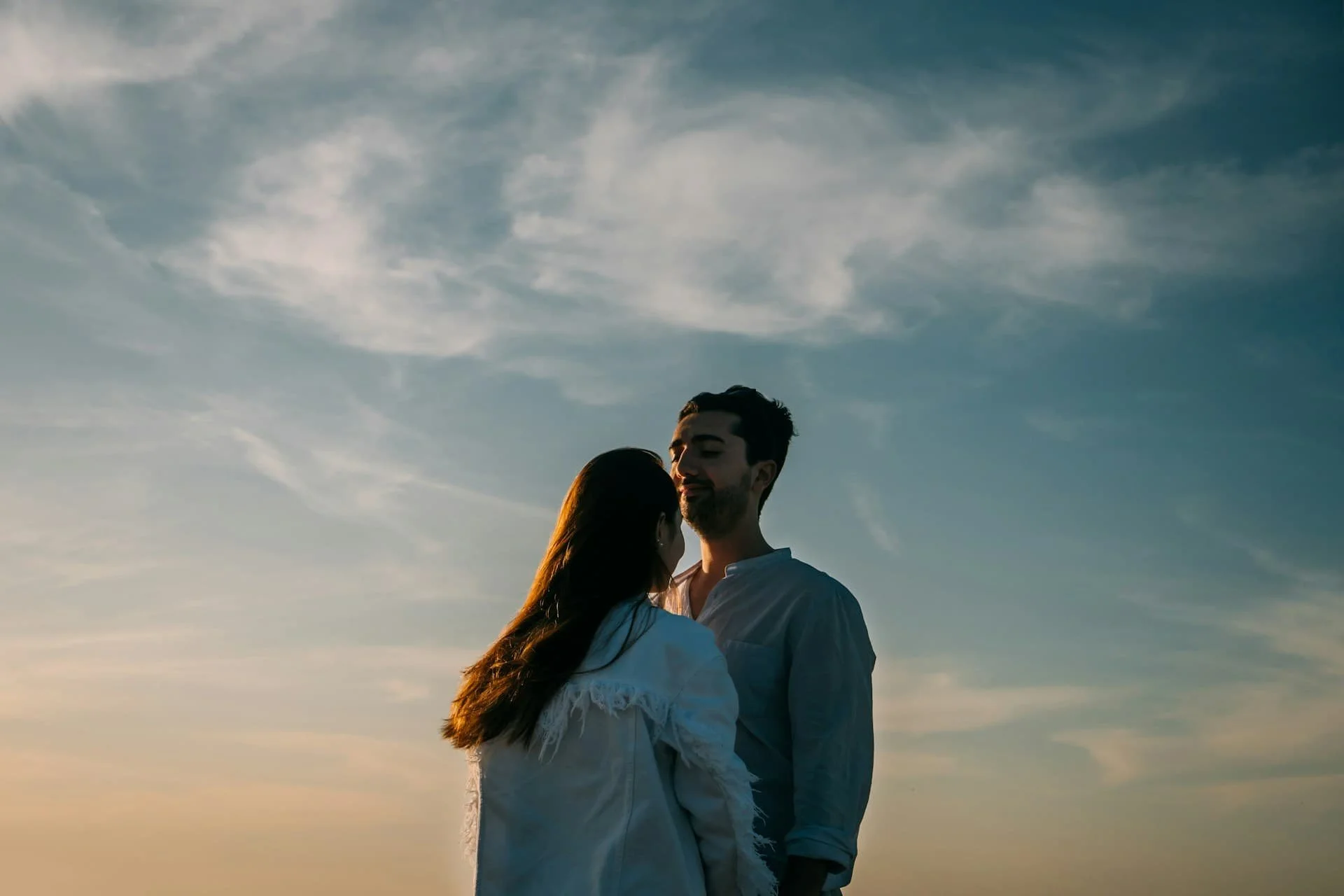 man-in-white-dress-shirt-standing-beside-woman-in-white-dress-shirt