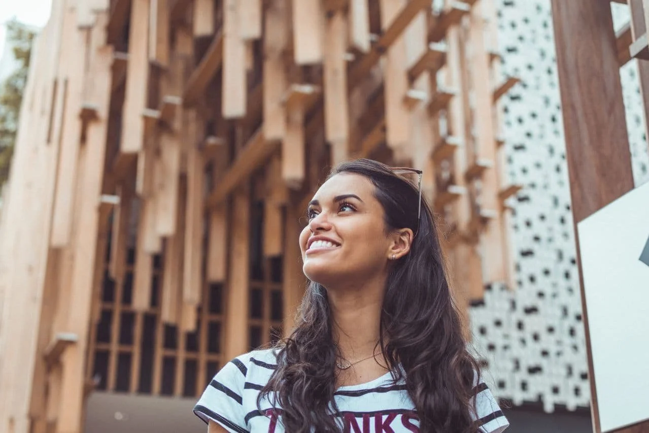 woman-wearing-white-and-black-striped-t-shirt-smiling-posing-for-photo