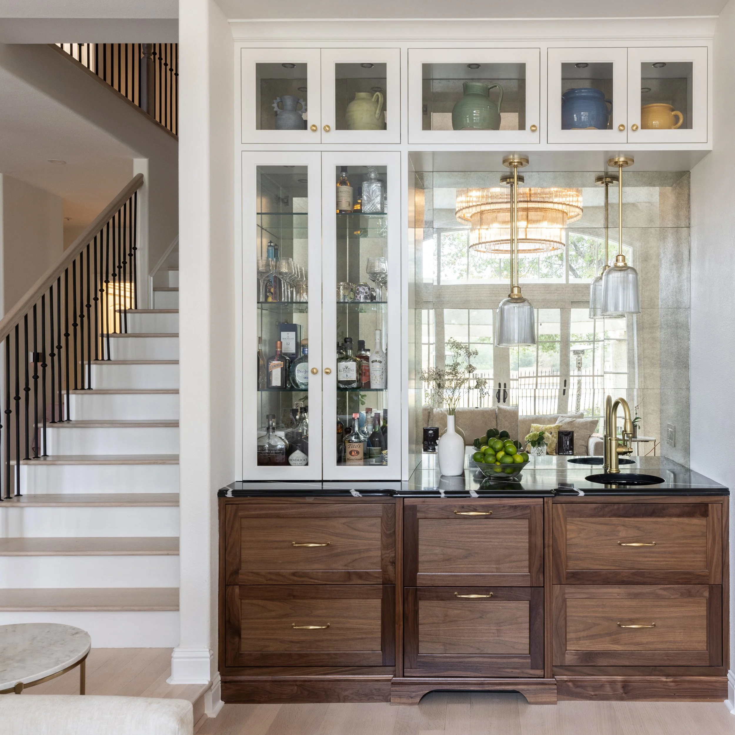 French Country Estate remodel with custom walnut bar cabinets and brass fixtures by Studioayse