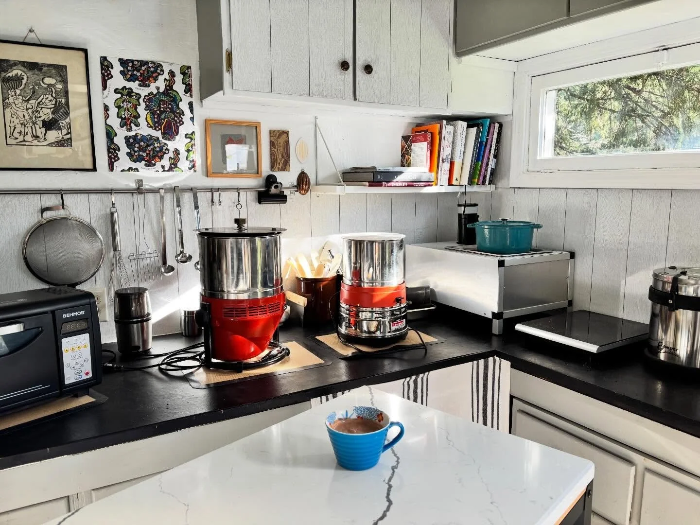 Small kitchen ❤️ Natural light helps 🌞 having everything within reach saves time 🐌 small batch equipment is perfect for small space crafting 🫘 no matter which chocolate products we make ☕️ crafting with joy is the 🔑 🤎