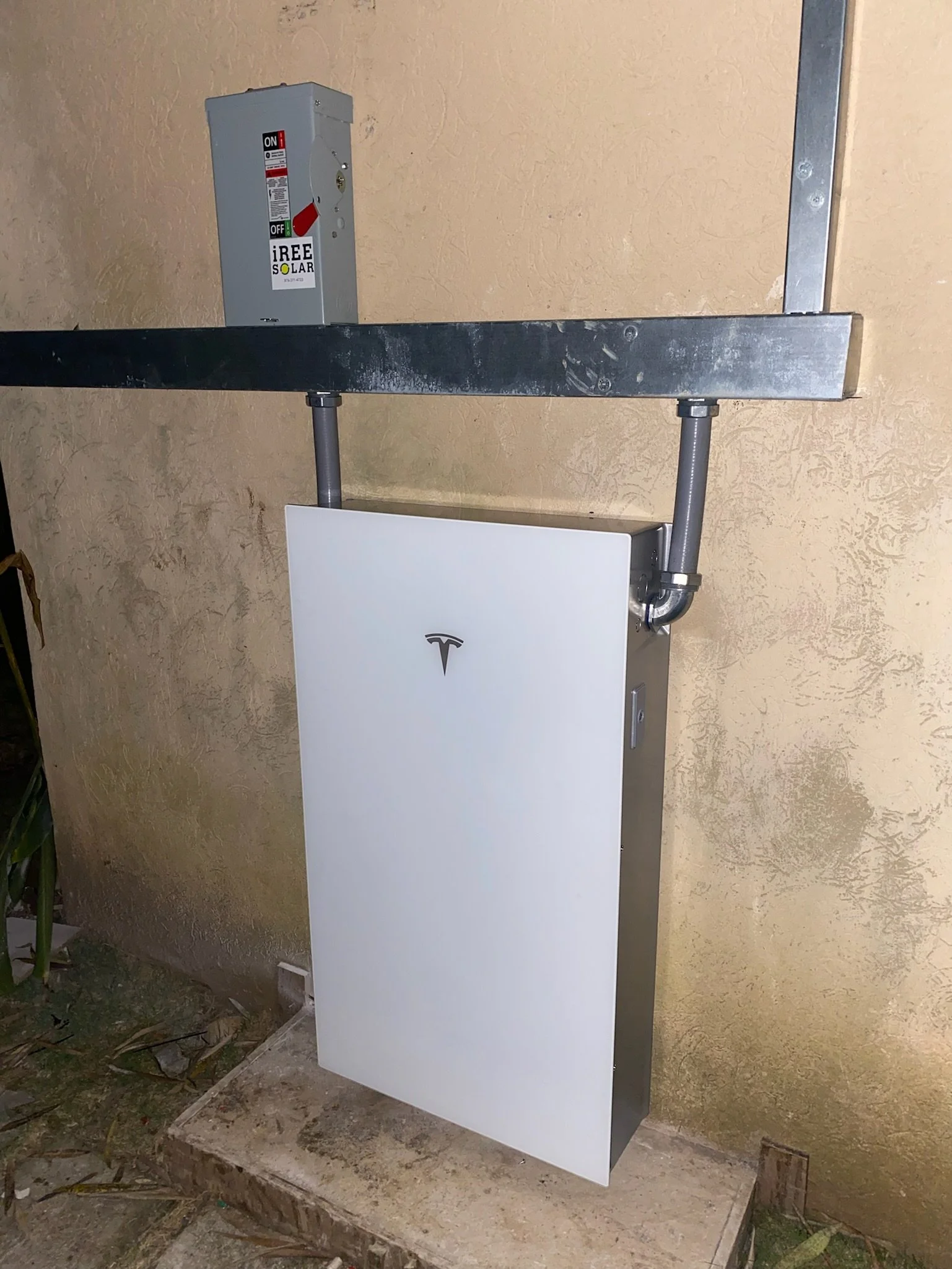 Tesla powerwall 3 installed outside on a wall