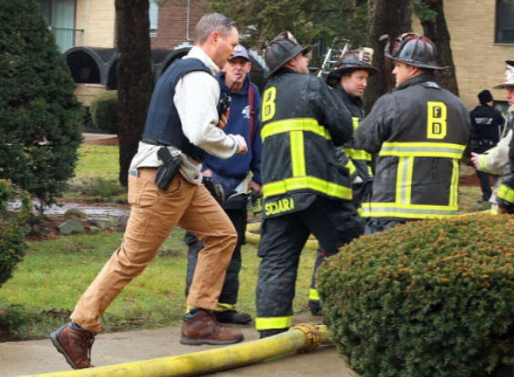 A Boston police officer ran to an apartment building at the Fairlawn Apartments in Mattapan after a suspect who fired a gun at
firefighters was captured