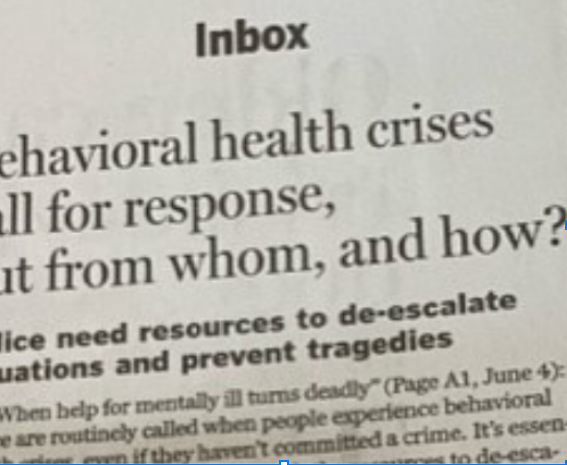 A printed article with the heading 'Inbox' and text discussing behavioral health crises and resource needs.