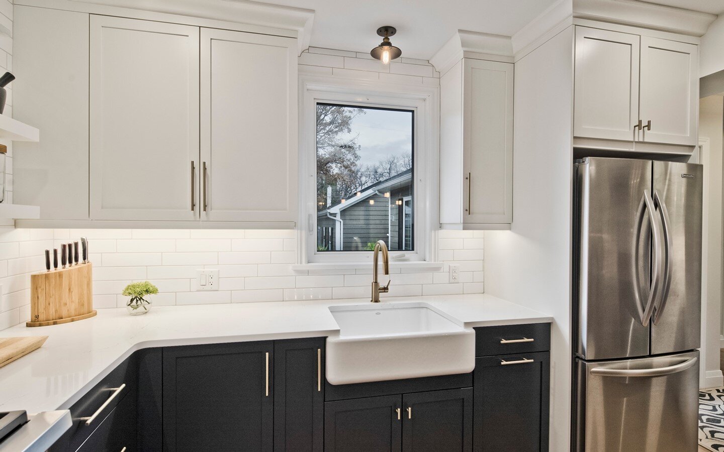 White on black cabinets add depth and dimension to this kitchen. What do you think of mismatched cabinetry?