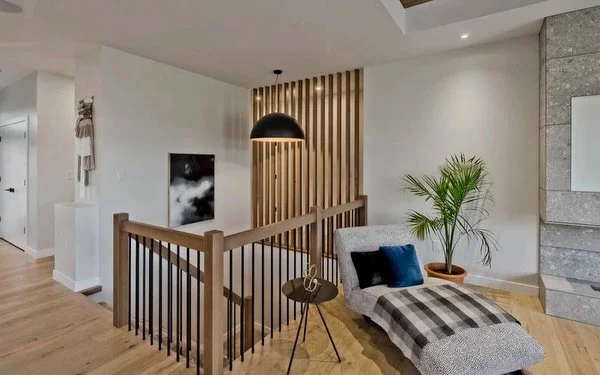 An element like wood slat detailing can bring a unique feel into your home. 

By carrying the same element throughout the home, they create cohesion while subtly defining different areas, and bringing warmth and texture into your space. 

Small detai
