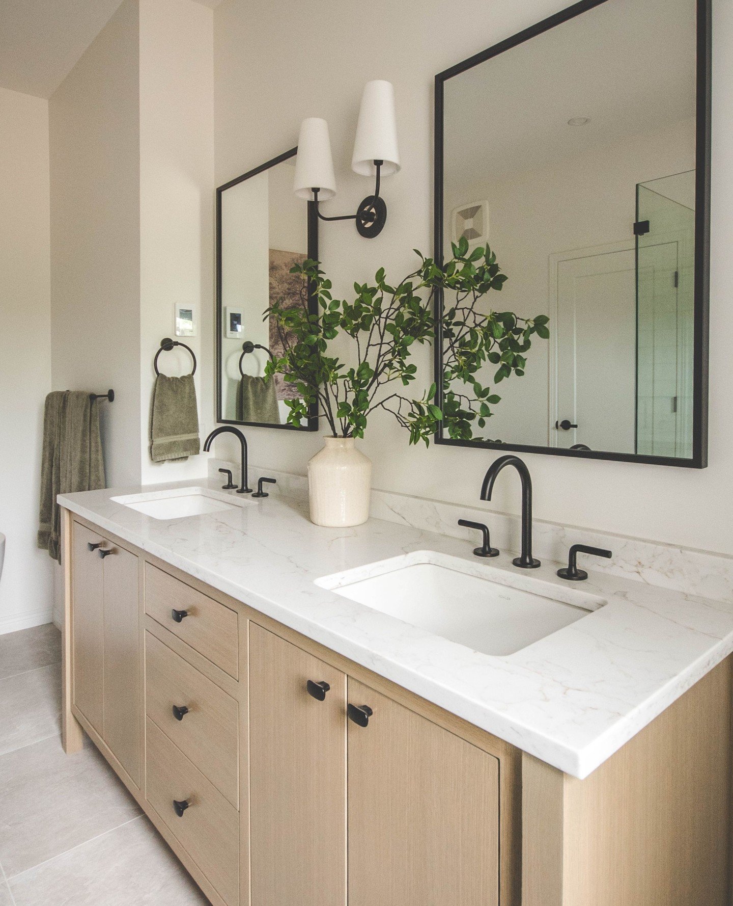 This warm, inviting ensuite is truly a private oasis. ⁠
⁠
A spacious dual-sink vanity, a deep soaker tub, and a generous walk-in shower come together in a palette of soft neutrals and grounding wood tones for a space that feels balanced and inviting.