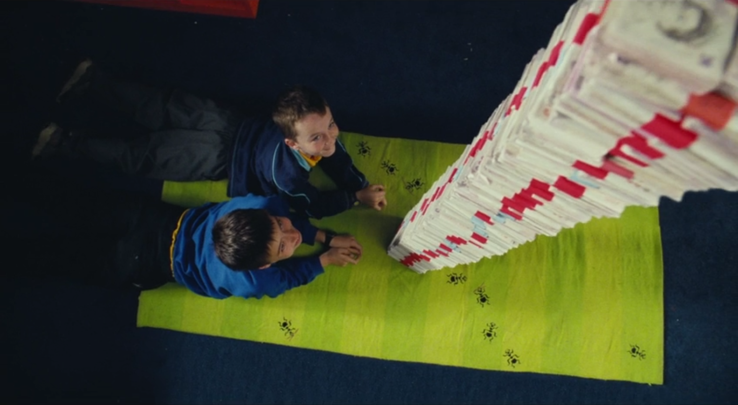 Brothers Anthony (Lewis Owen McGibbon) and Damian (Alex Etel) with a stack of the money they found.