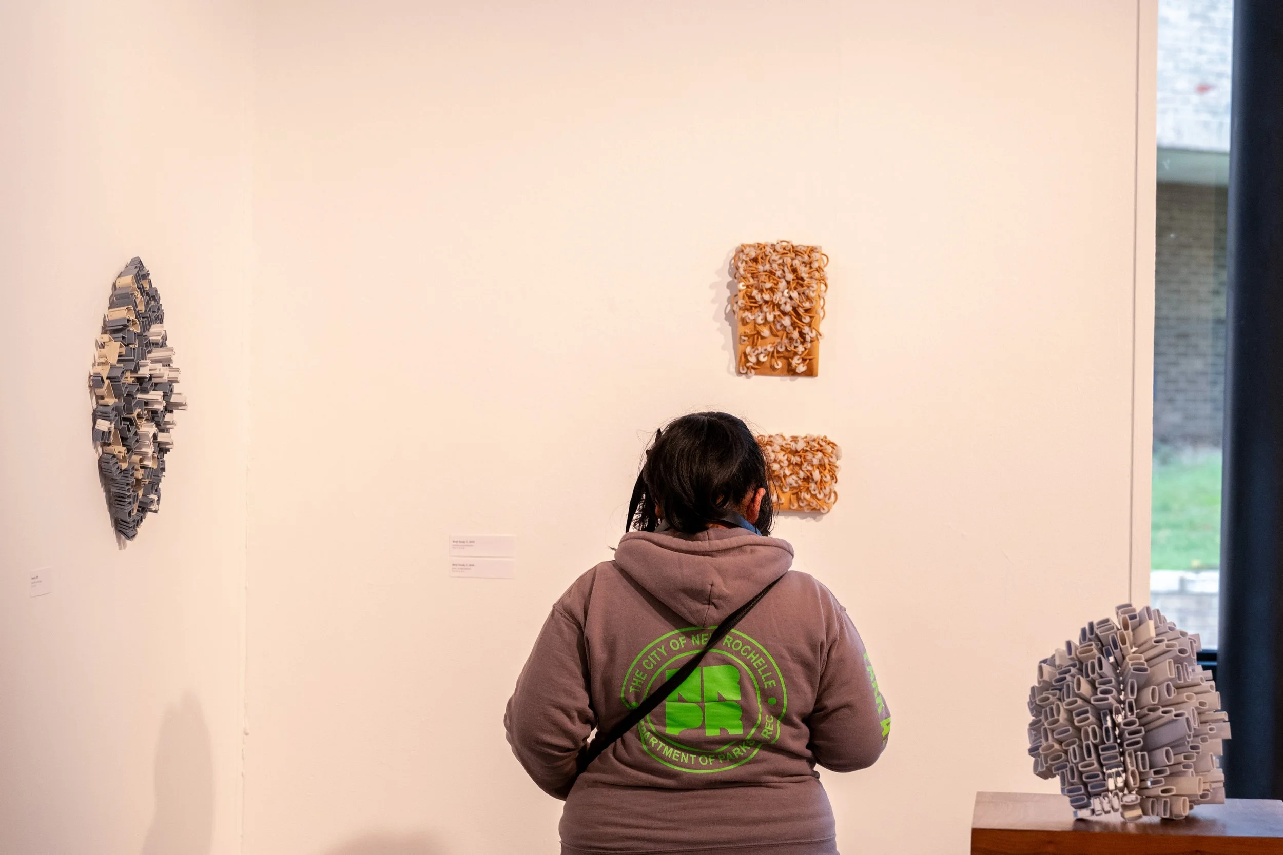 viewer looking at Kate Rusek sculpture
