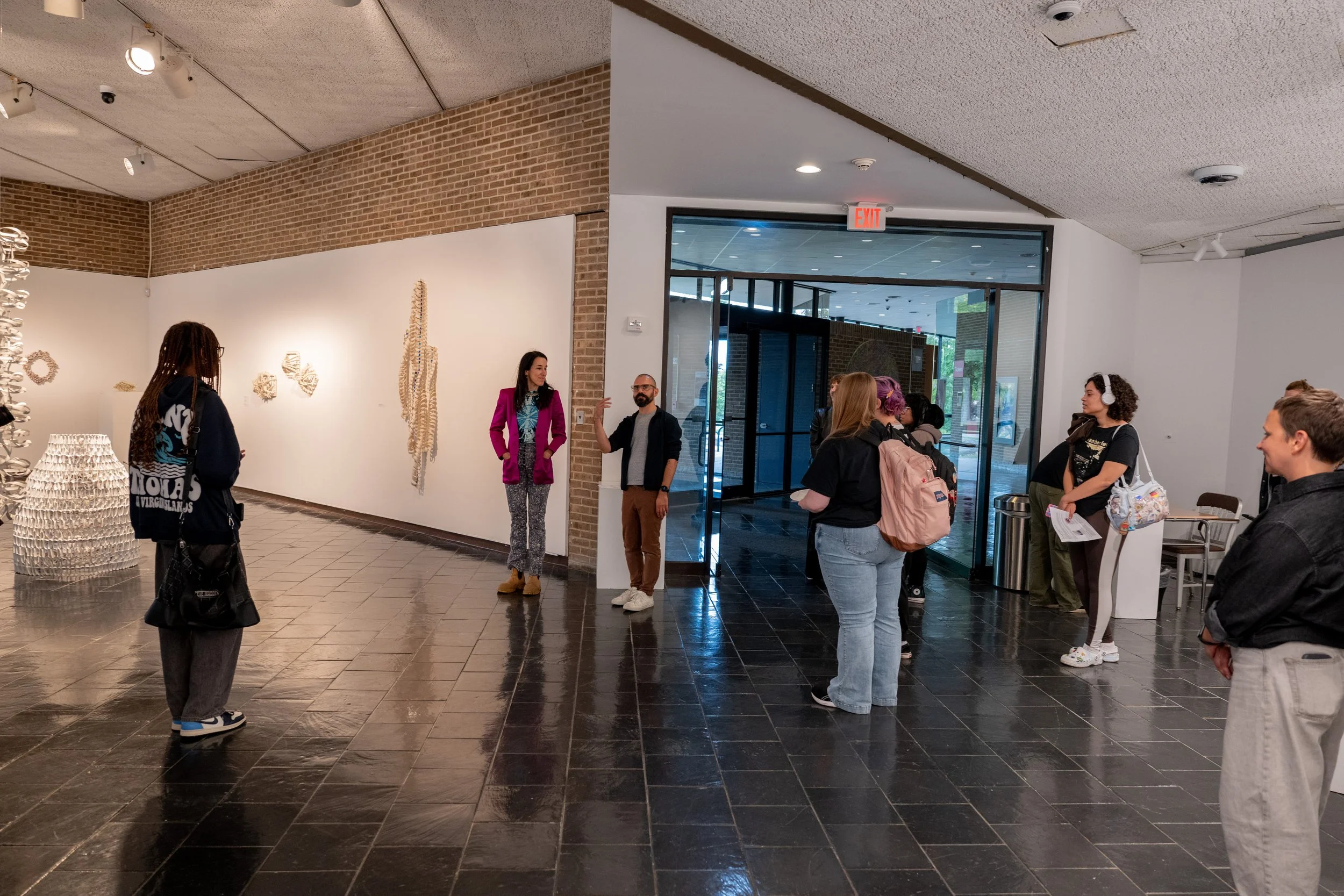 viewers looking at Kate Rusek sculpture installation