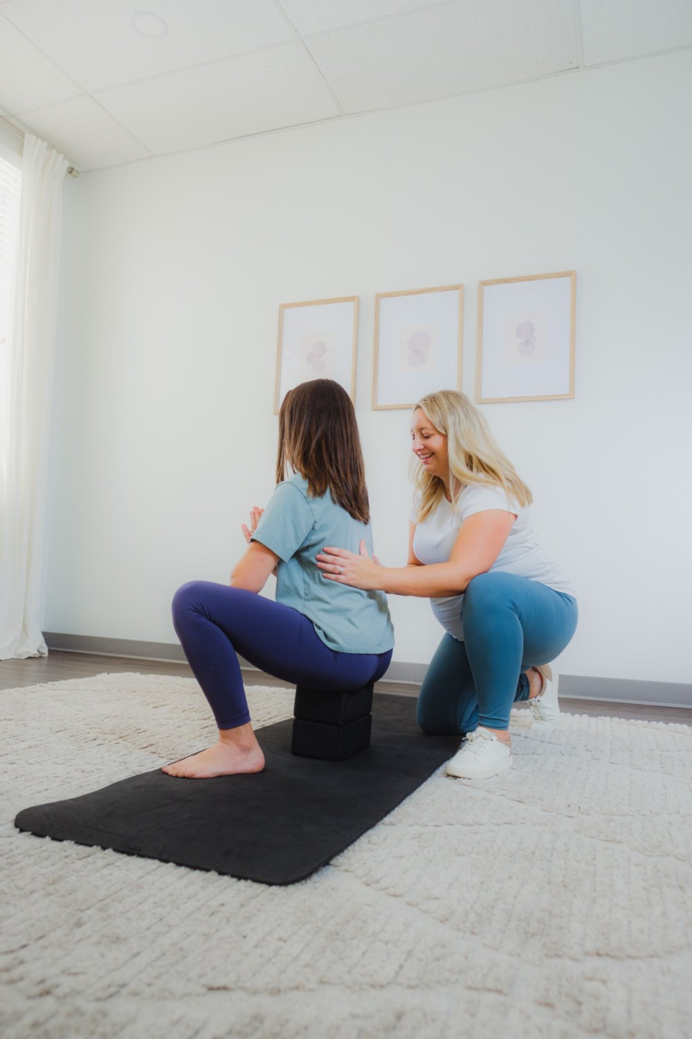 pelvic therapy treatment session for pregnant individual in a deep squat working on breathing and stretching