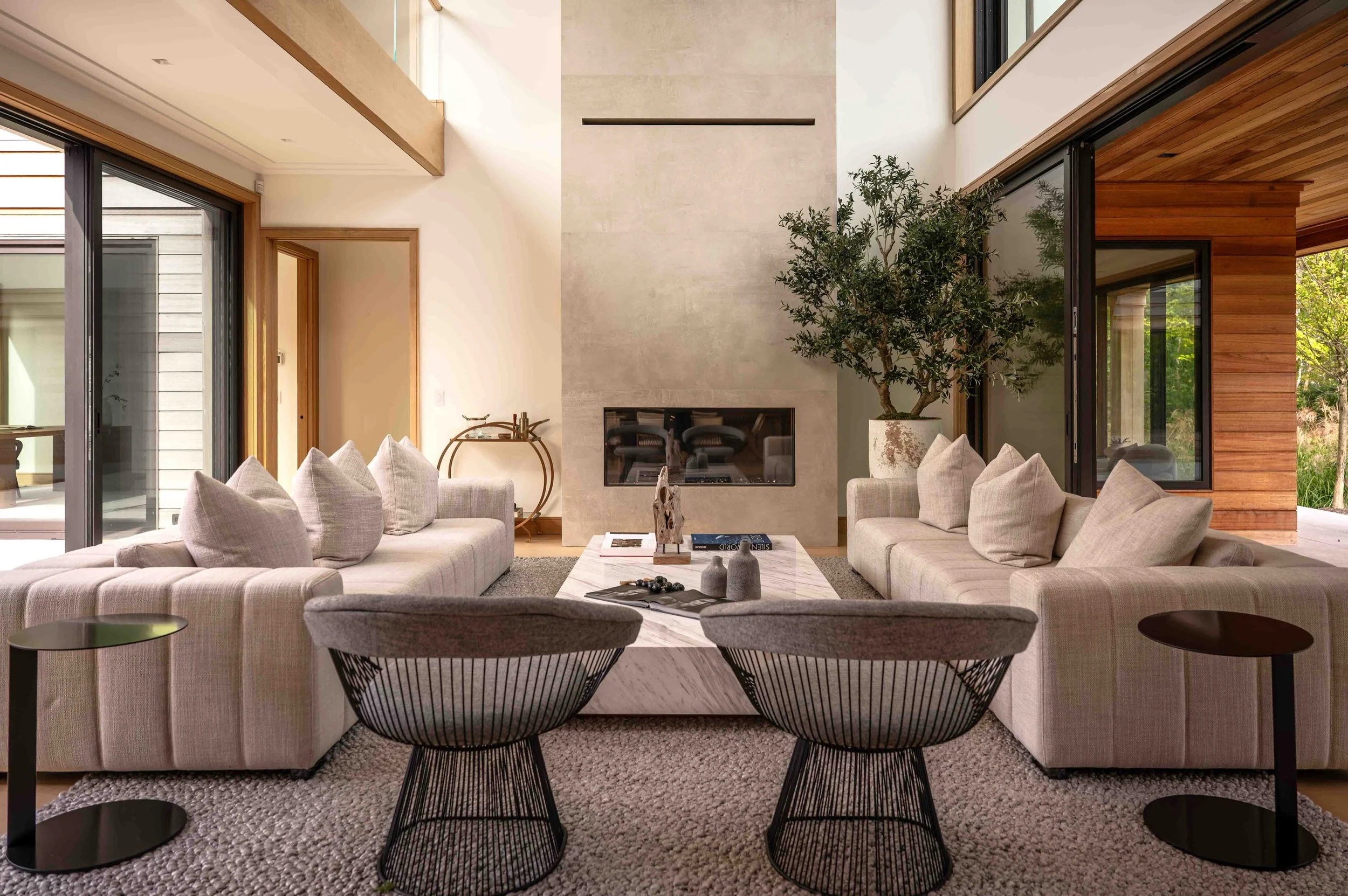 At 27 Fresh Pond in North Haven, expansive glass walls open to the surrounding landscape, creating extraordinary sightlines and a seamless connection between indoors and out.

Our approach was intentional: furnishings that complement the architecture