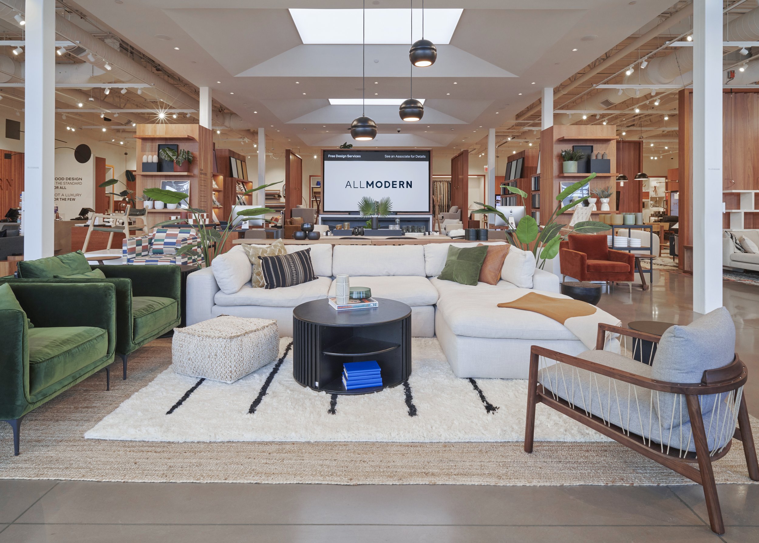 Modern furniture store interior with sectional sofa, chairs, and a variety of home decor items.