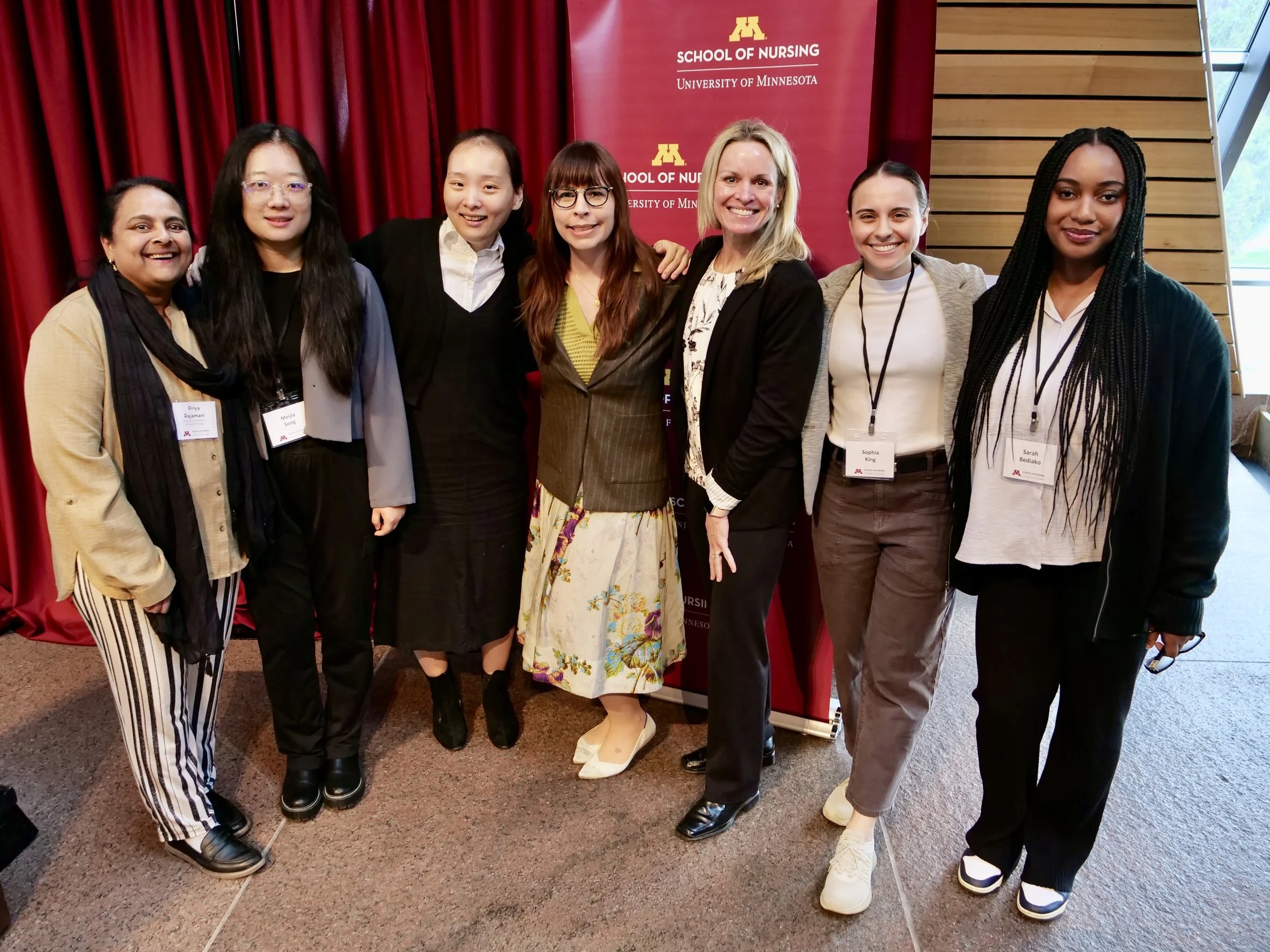 Seven people, including Malin Britt Lalich, on a stage at UMN School of Nursing Research Day 2026.