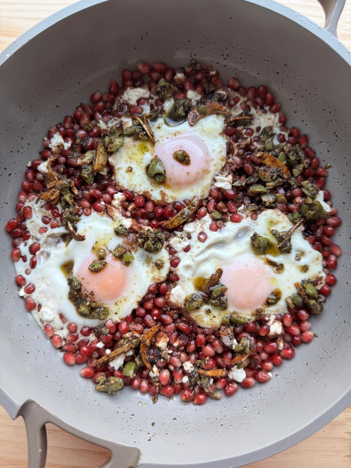 pomegranate + feta eggs with za’atar olive crunch