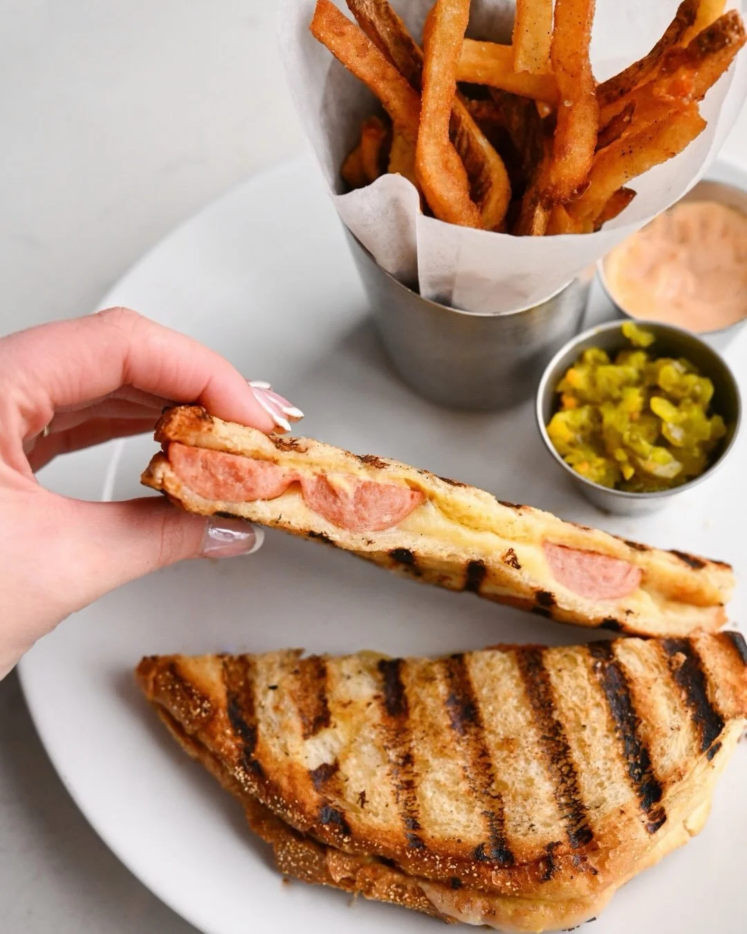 Crispy, melty, and oh-so-satisfying. 
Hot dog, but make it a panini. 🌭 
Now available on our Early Bar Menu, Tuesdays&ndash;Sundays from 4&ndash;6 PM. Early bites at the bar await!