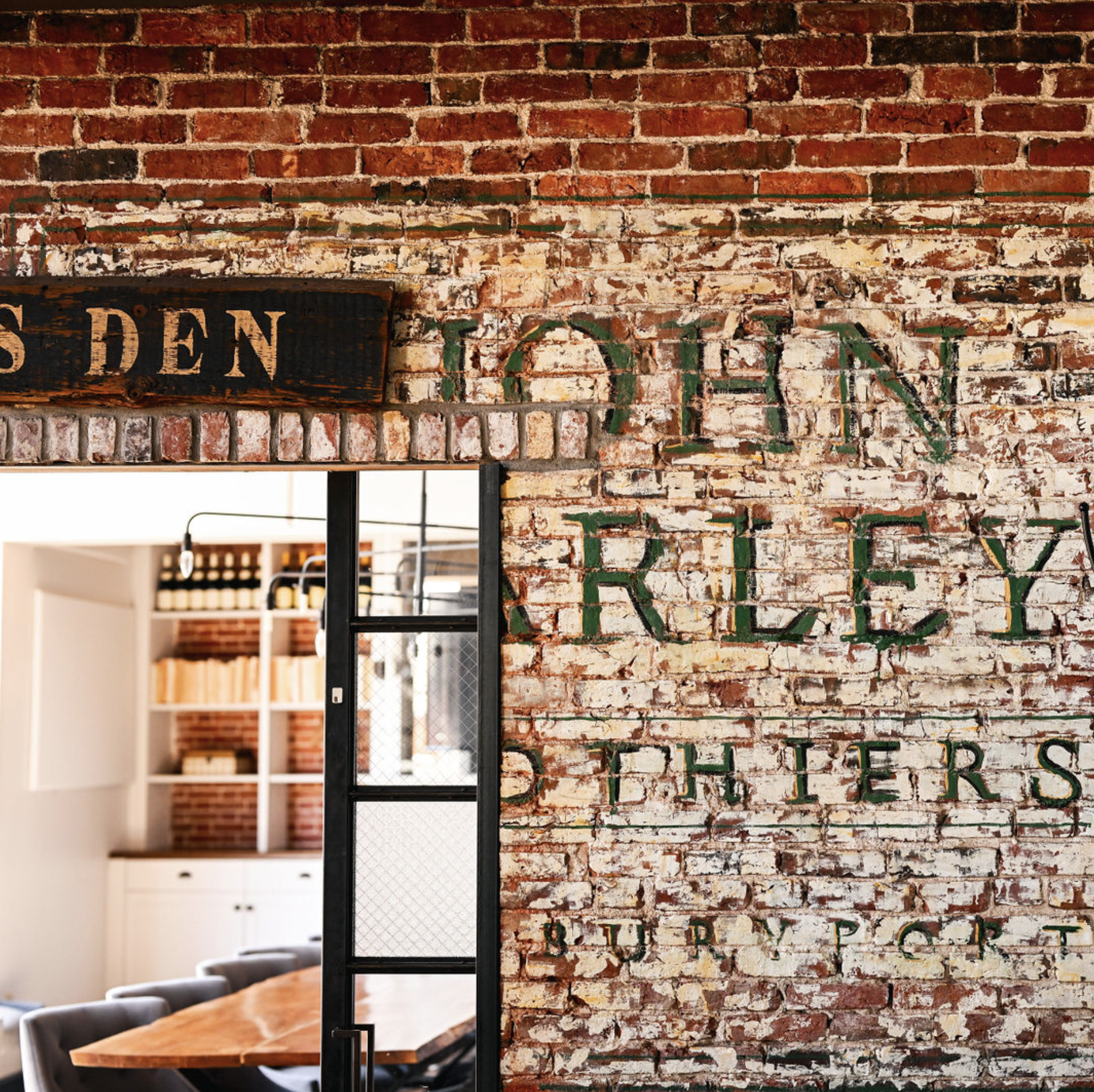 Restored John Farley Clothiers brick signage inside The Poynt, Newburyport MA