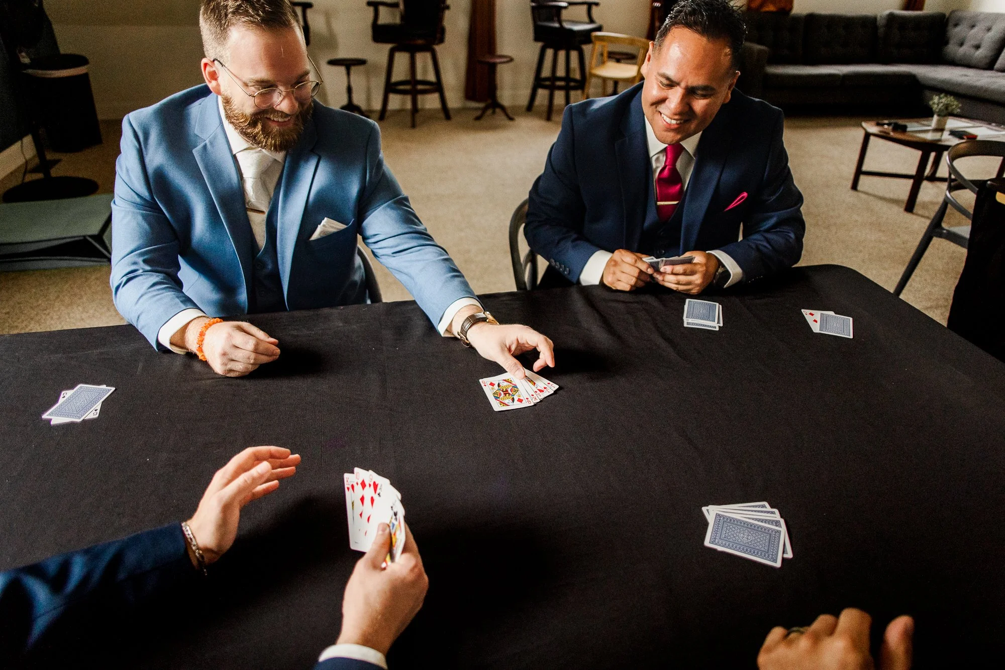 Groom playing euchre with groomsmen while waiting for his wedding ceremony