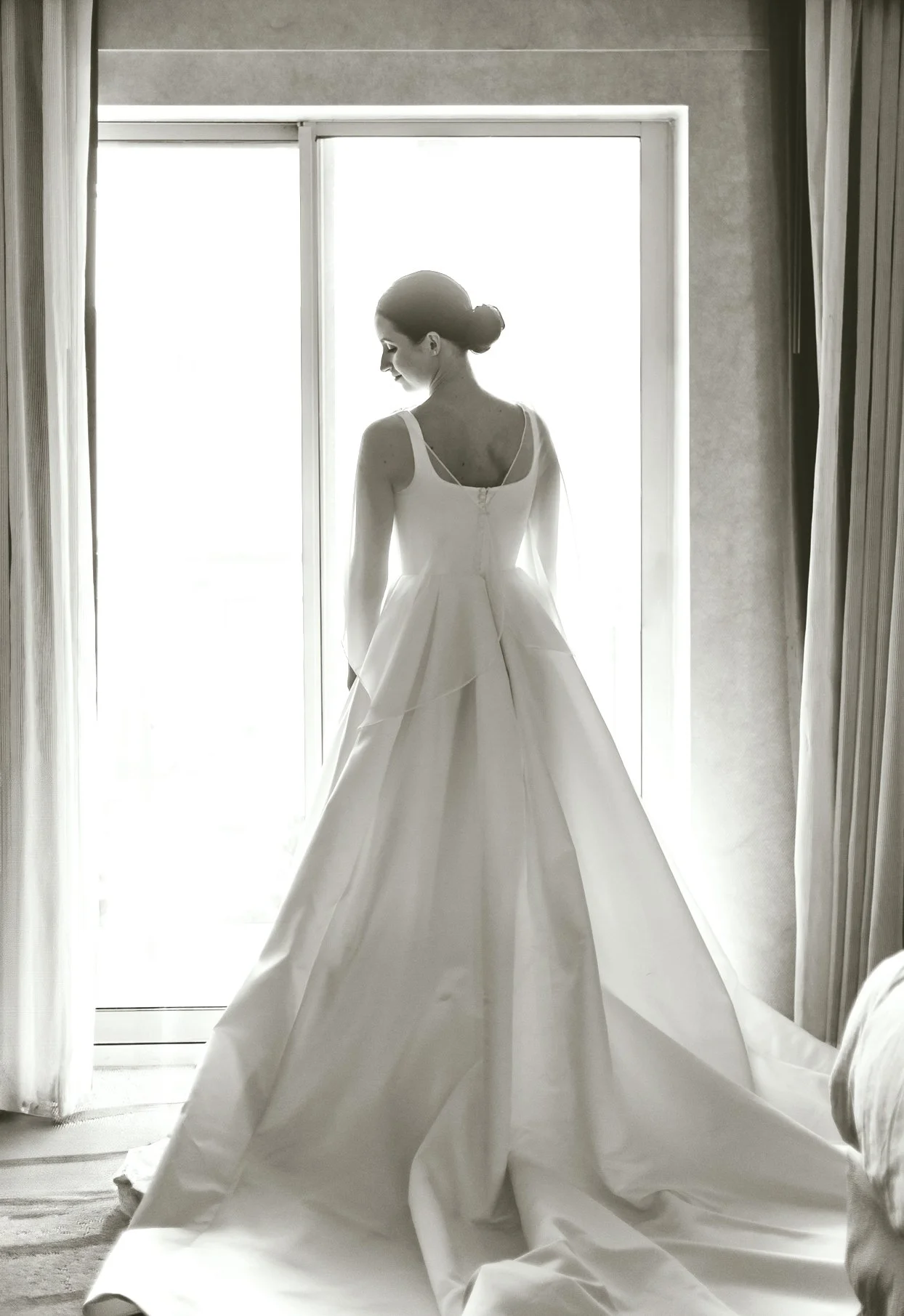Sarah standing in front of a large window at The Kingsley
