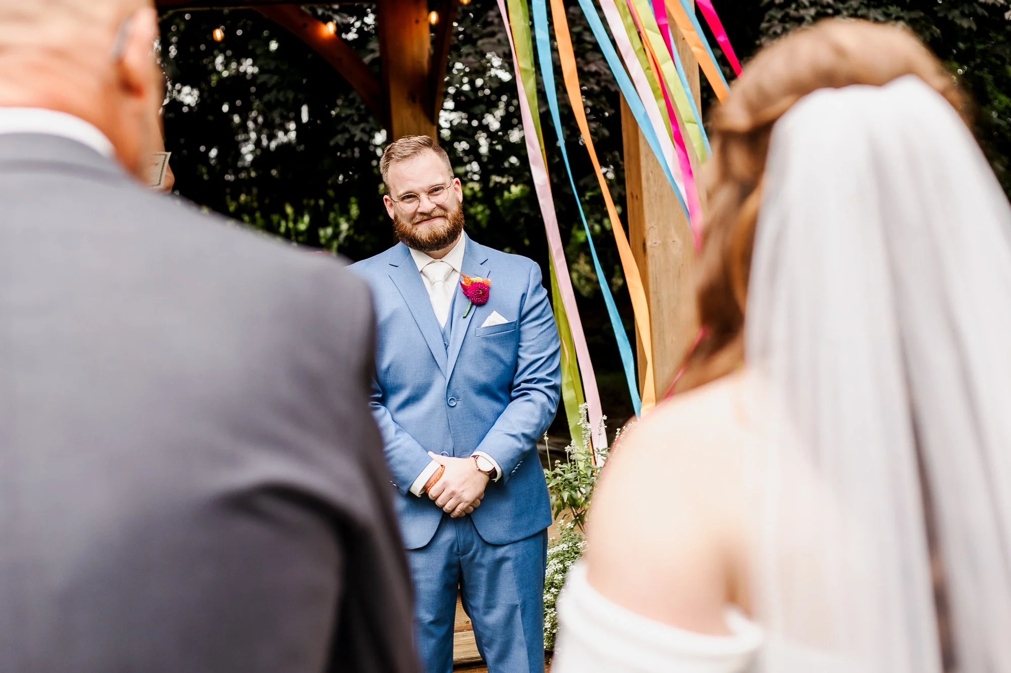 Close up of groom's reaction to see the bride walking down the aisle to him