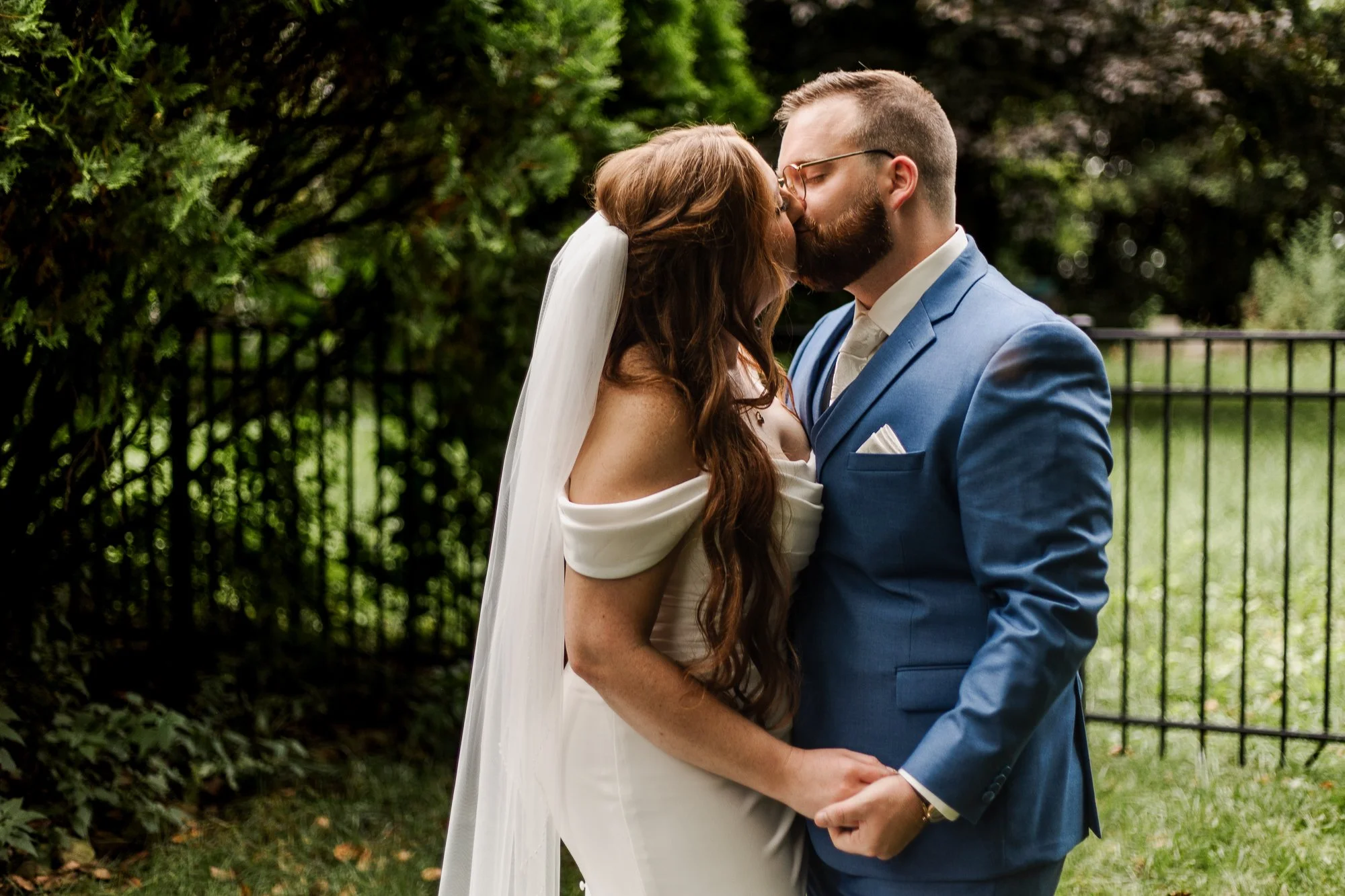 Close up portrait of bride and groom kissing  in garden at Bloom and Bower in Risingsun Ohio