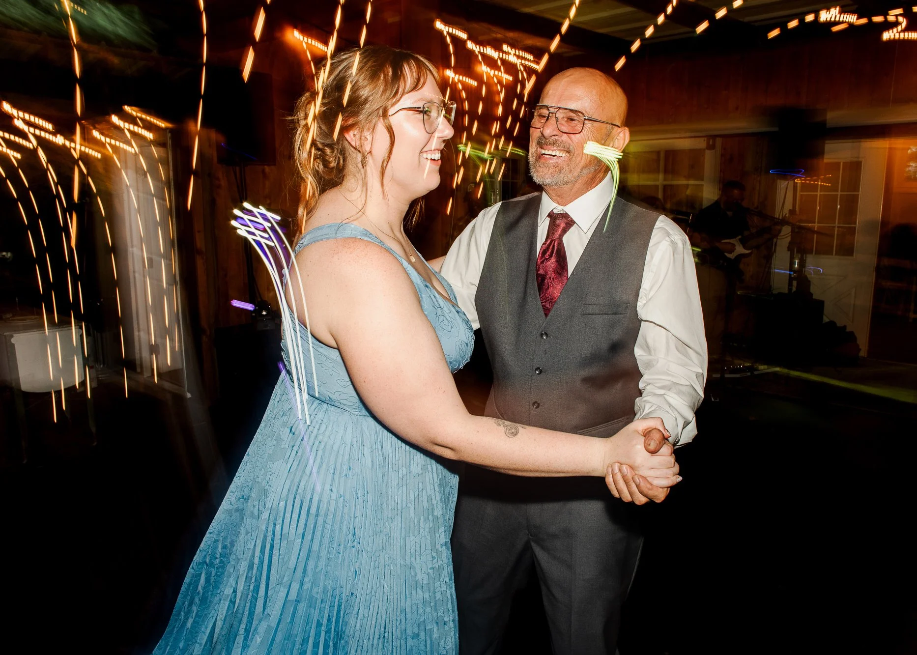 wedding guest dancing together on a dark dance floor