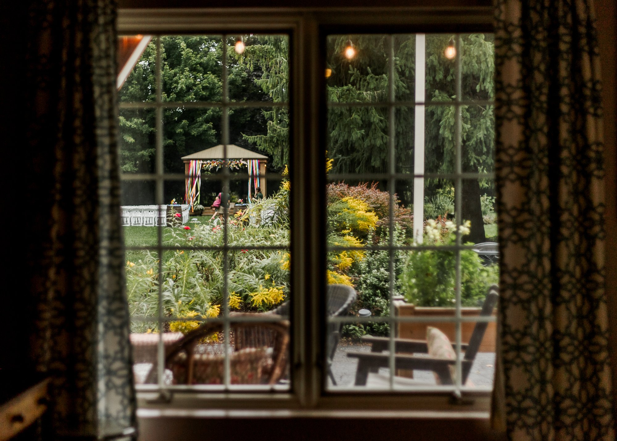 Looking through the bed and breakfast window at the ceremony gazebo on the lawn of Bloom and Bower in Risingsun, Ohio