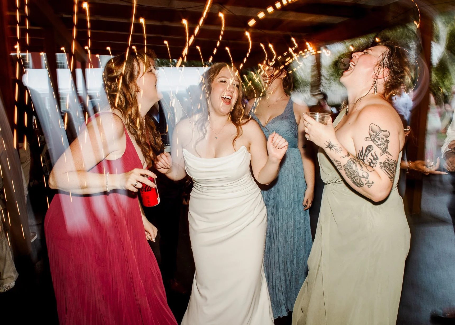 wedding guest dancing together on a dark dance floor