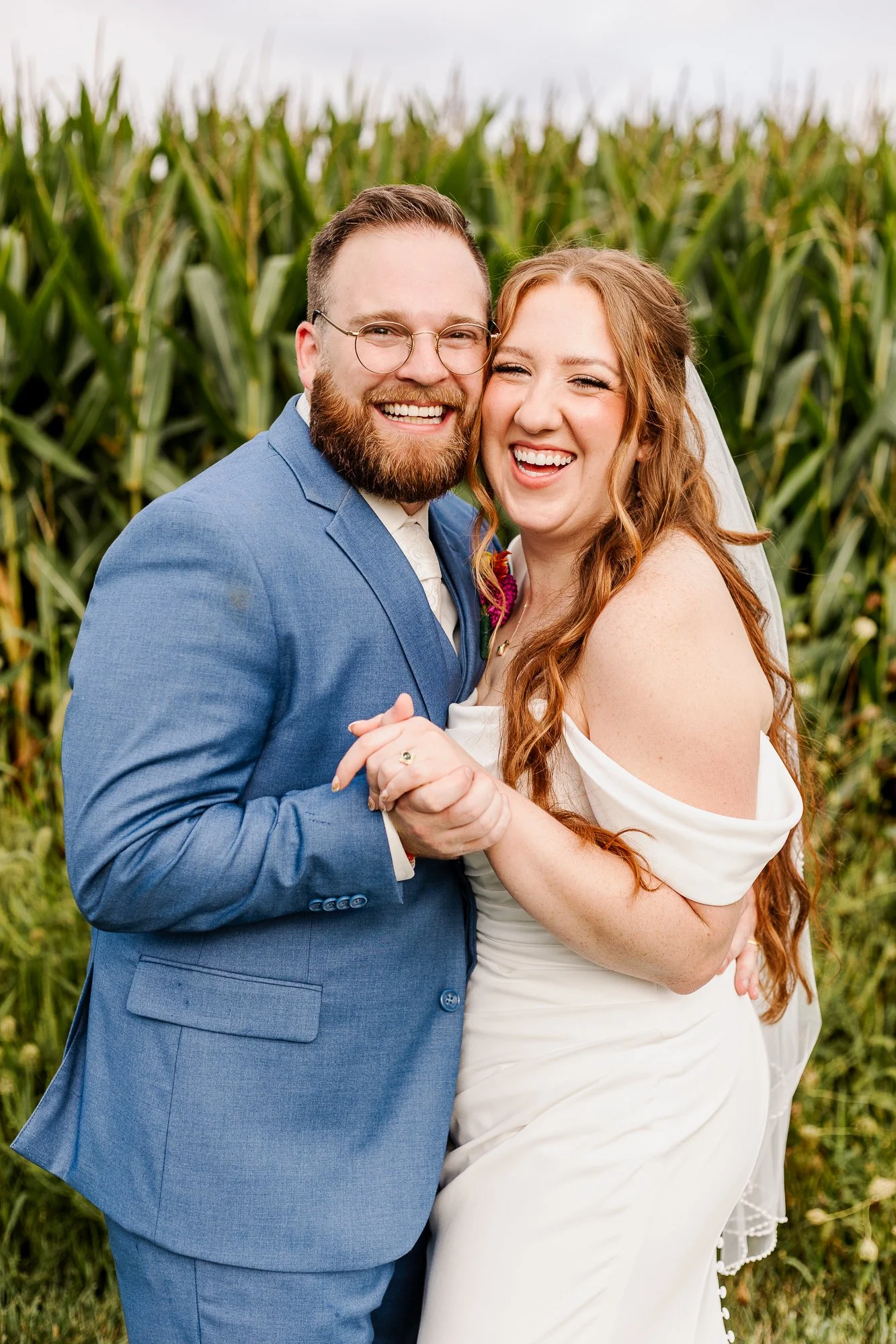 close up portrait of bride and groom laughing in front of a corn field at bloom and bower in rising sun ohio