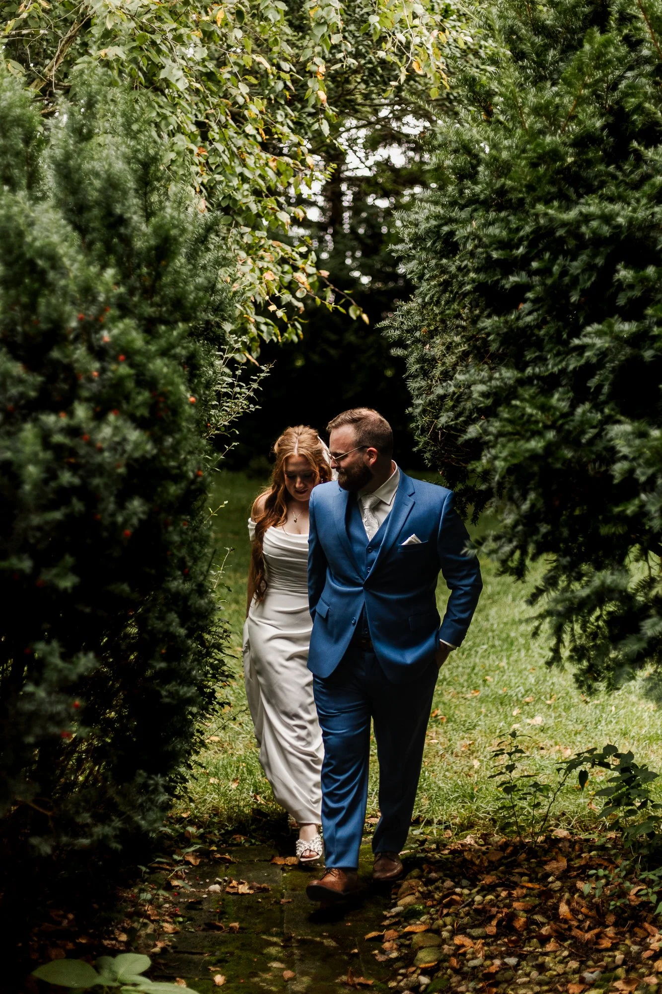 Bride and groom walking through garden at bloom and bower in rising sun ohio