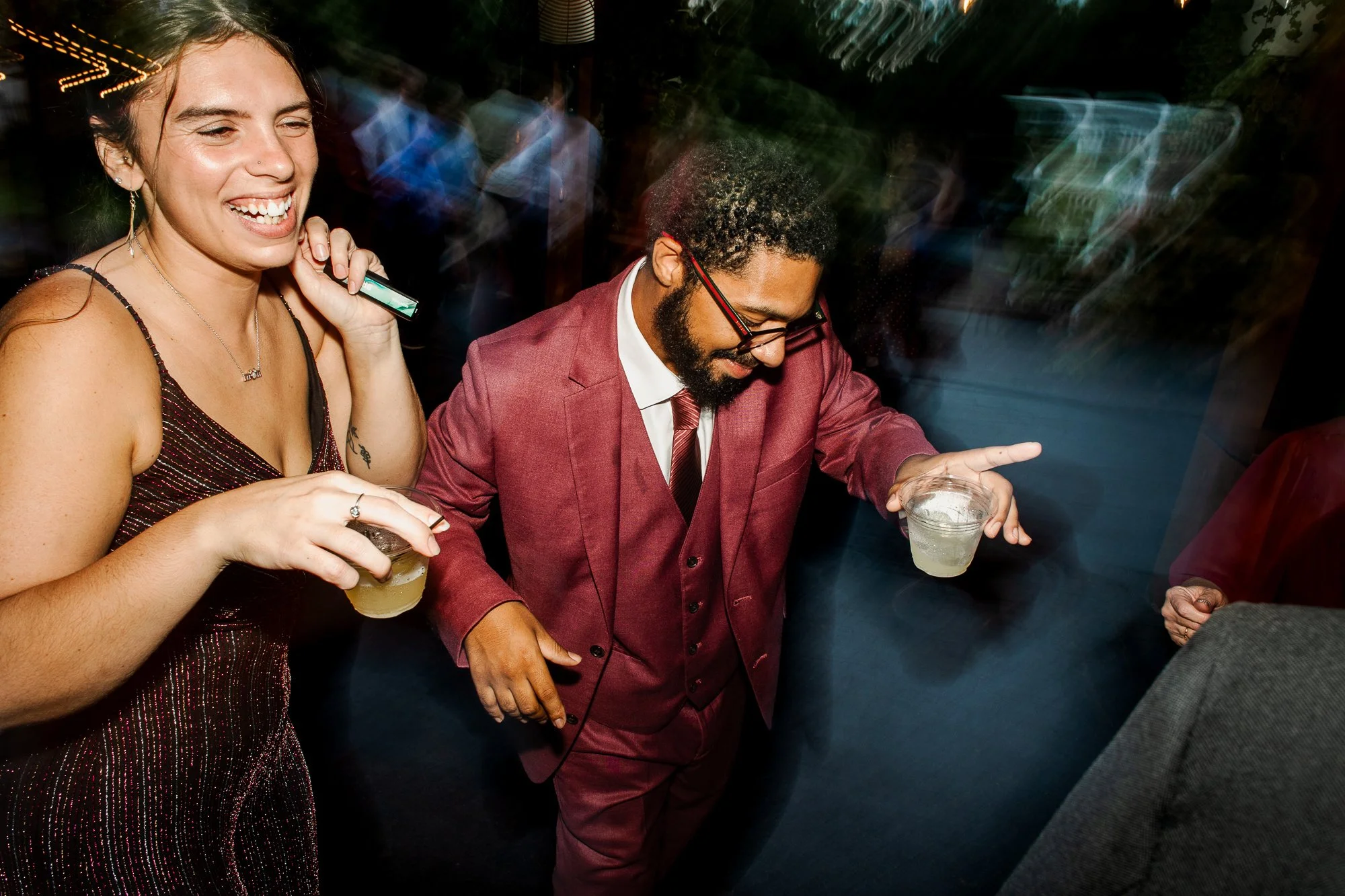 wedding guest dancing together on a dark dance floor
