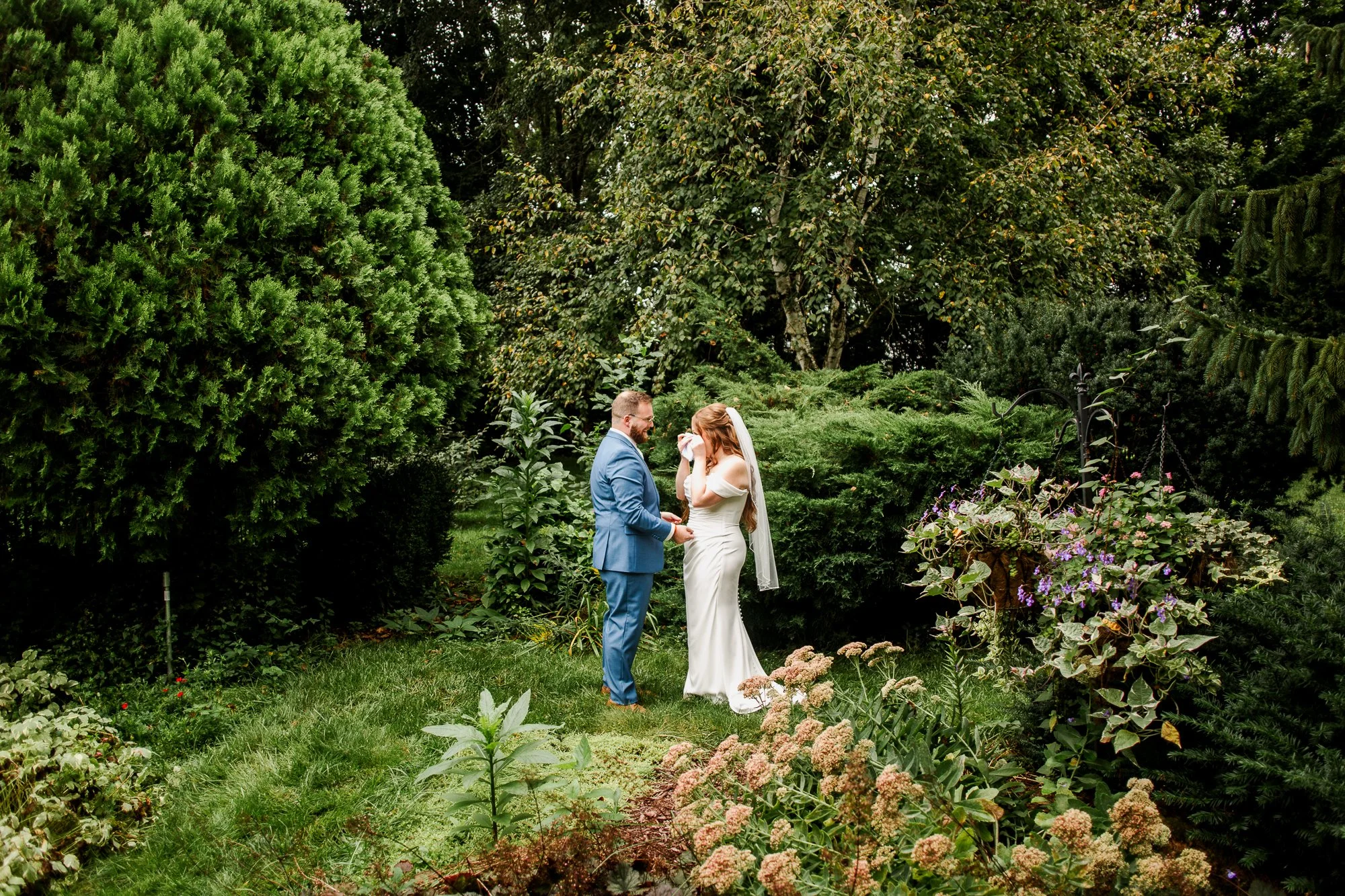 Bride wipes tears from her eyes during first look at Bloom and Bower in Risingsun, Ohio