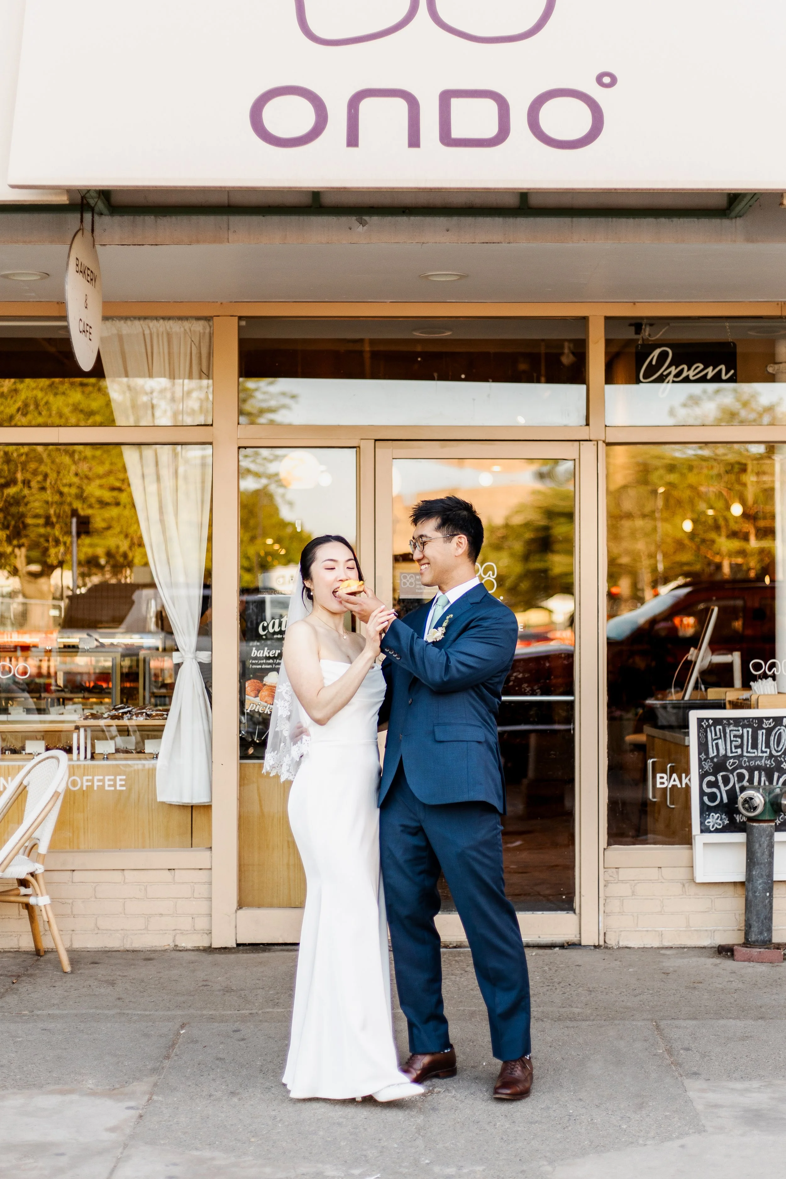 Bride and groom in front of Ondo bakery in Ann arbor, Michigan