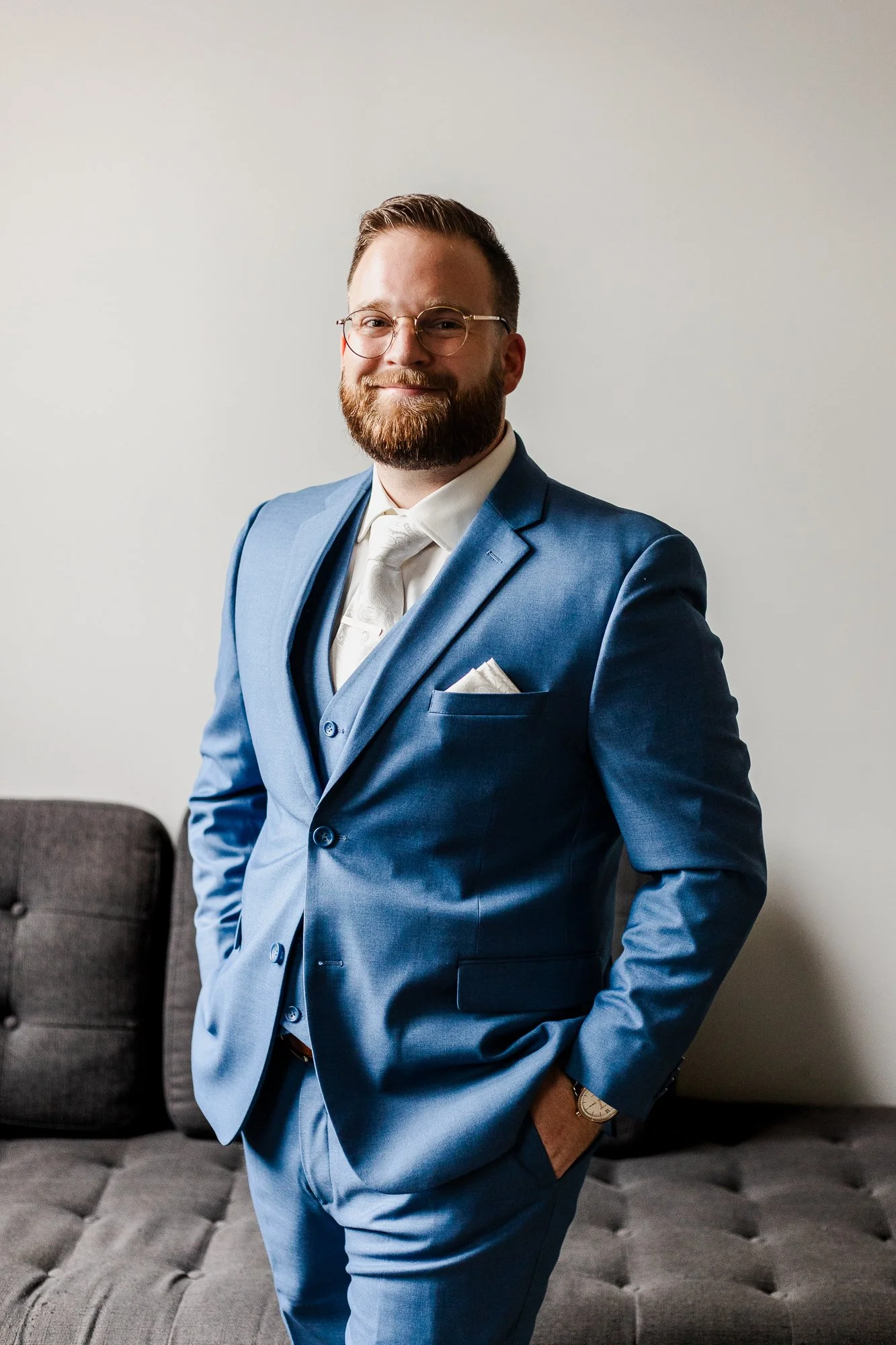 Half portrait of groom in a blue tux on his wedding day