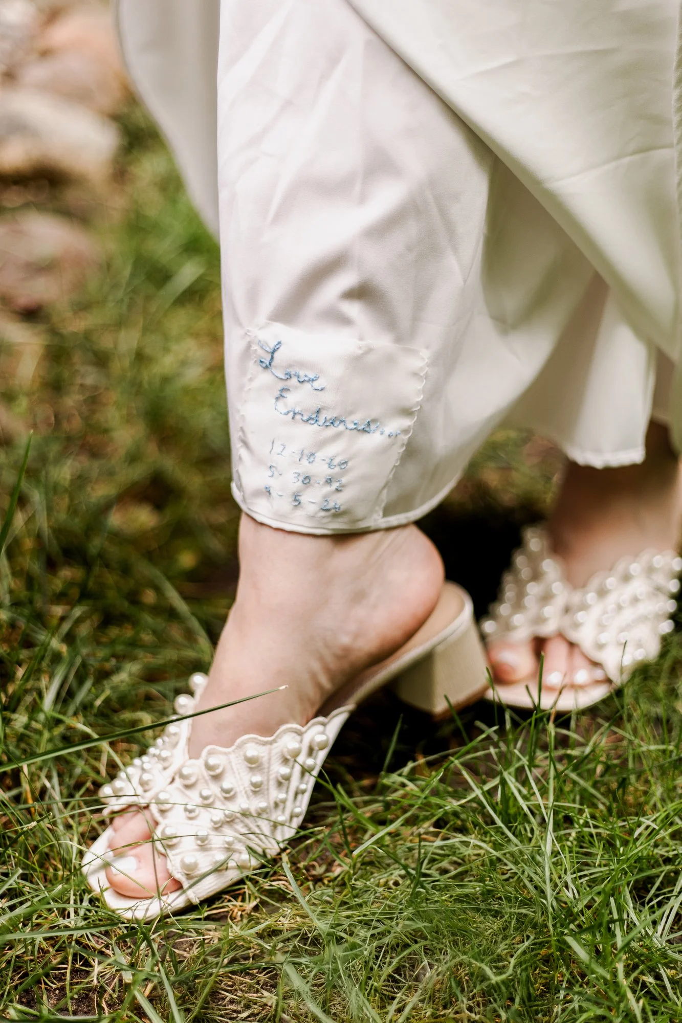 Bride showing close up of wedding dress detail
