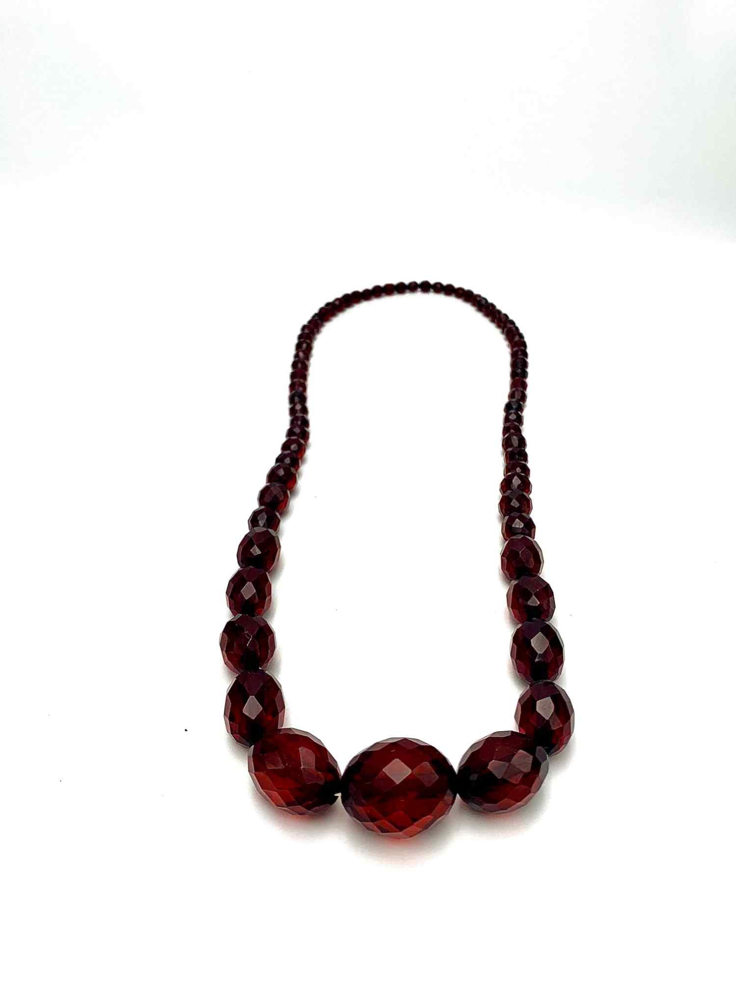 Necklace made of 25 ovoid plastic beads (cherry amber?).… | Drouot.com