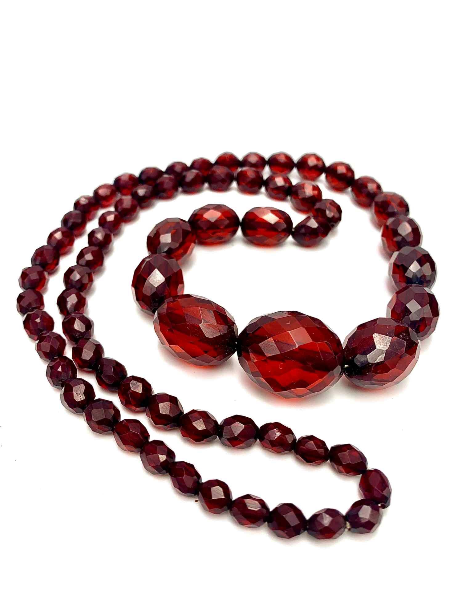 Sold at Auction: A CHERRY AMBER TYPE BEAD NECKLACE. 53 grams. 68 cm long.