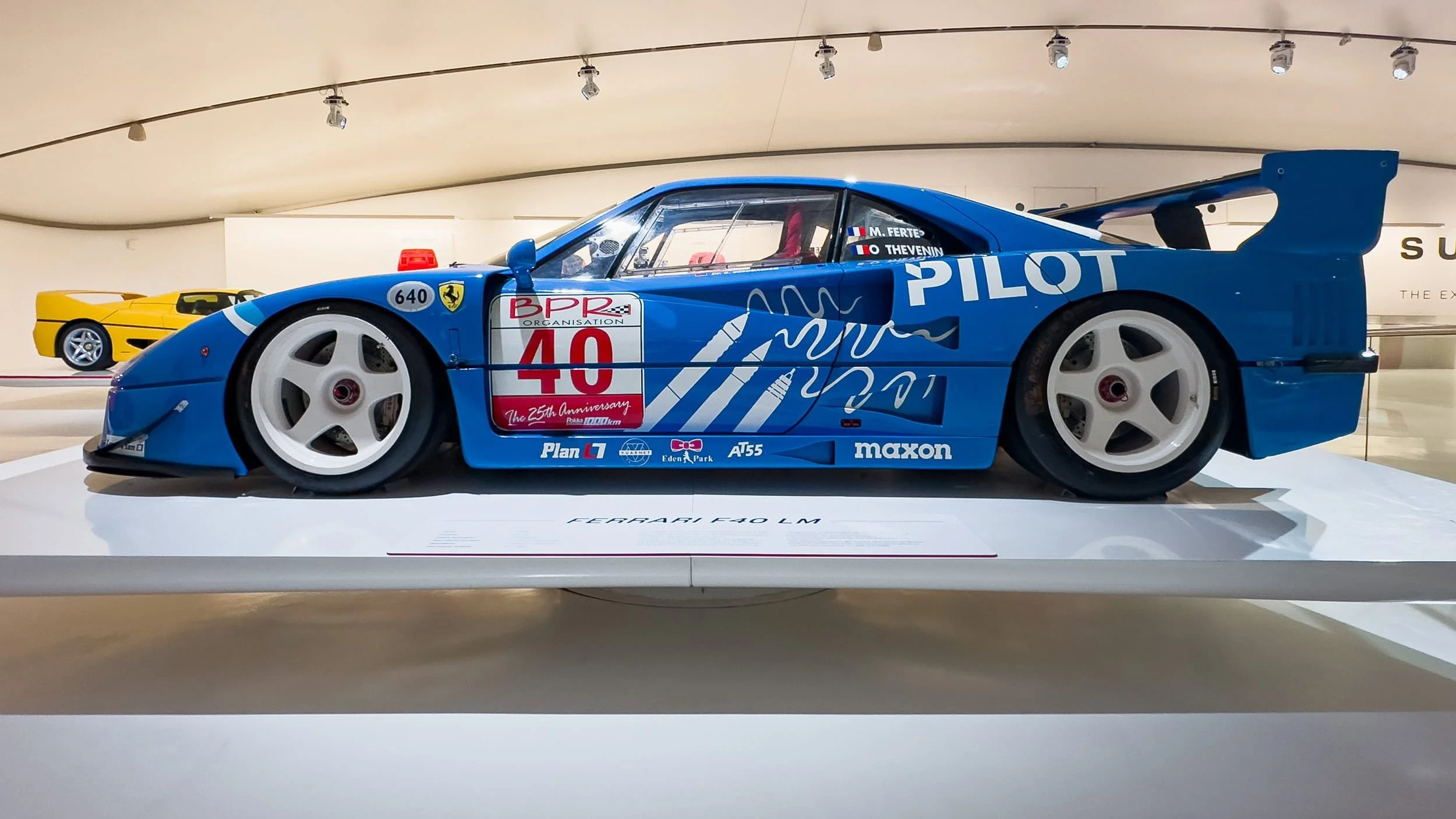 A Ferrari F40 LM race car is displayed in striking blue livery, displayed at the Museo Enzo Ferrari in Modena Italy.