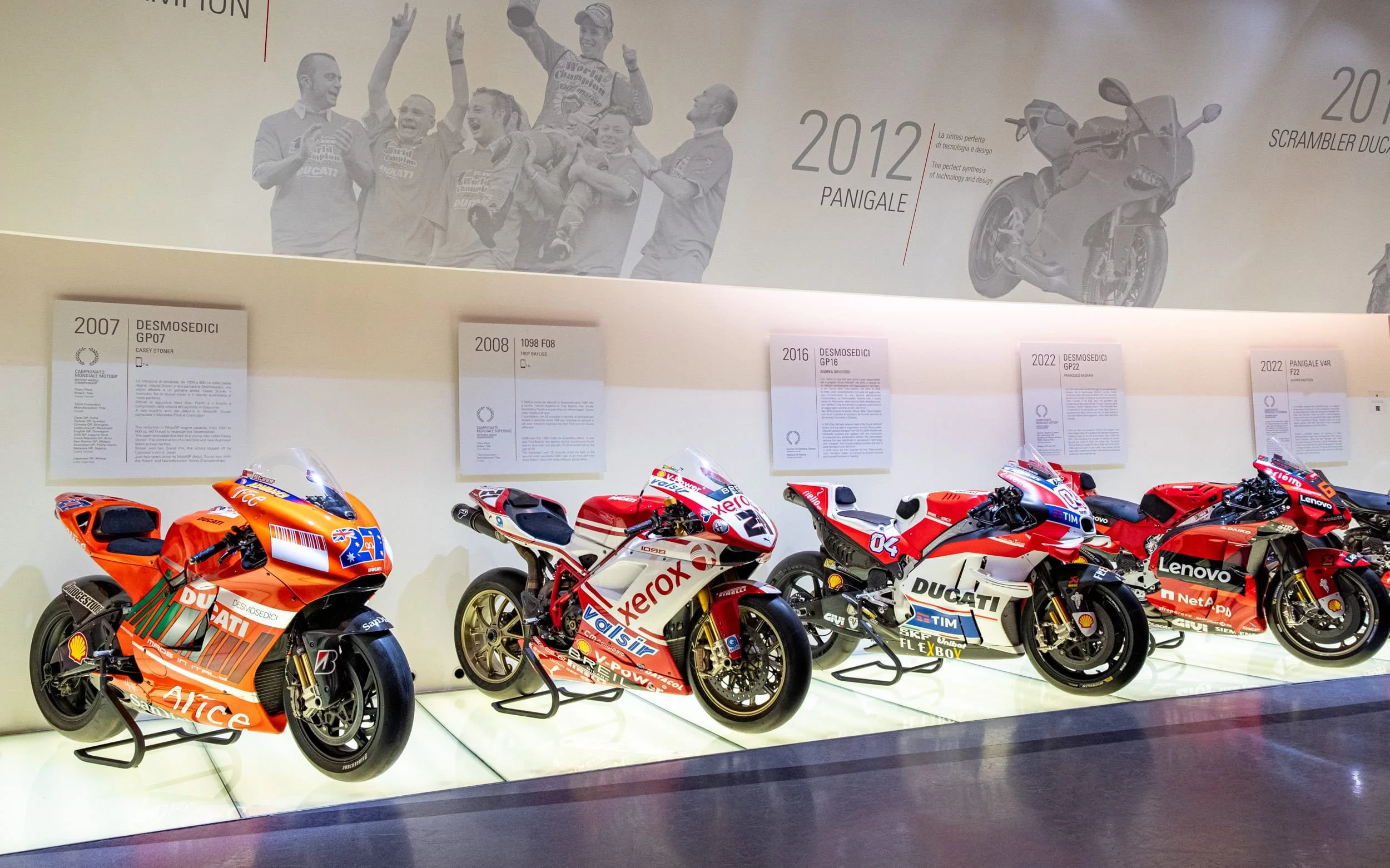 Historic Ducati MotoGP and racing motorcycles displayed inside the Ducati Museum in Bologna, Italy, showcasing championship-winning bikes from different racing eras and technological milestones.