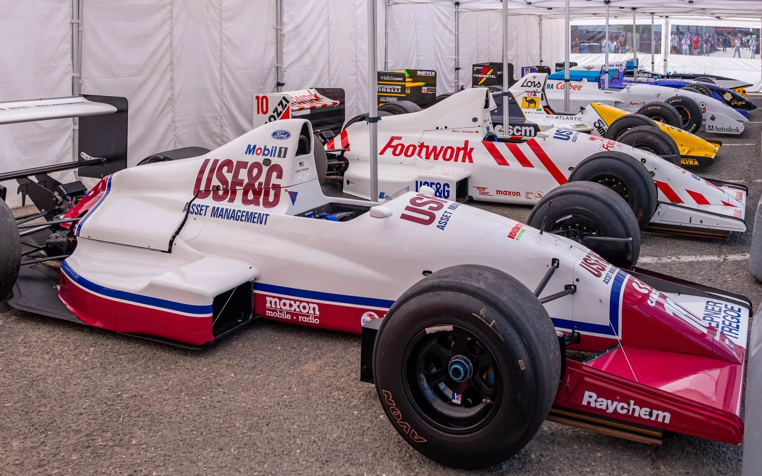 Several F1 cars from the 1990s on display at the 2025 Imola F1 Grand Prix.