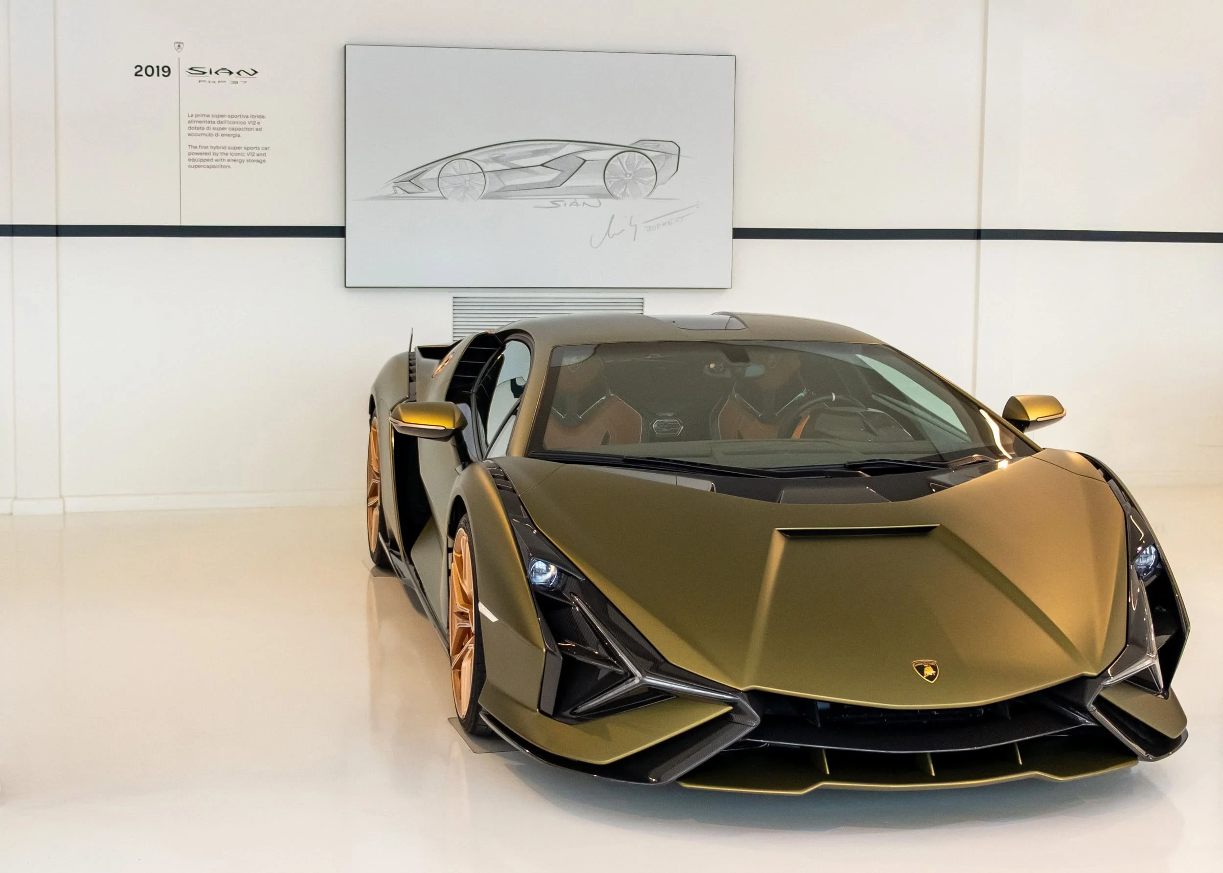 Front view of Lamborghini Sian FKP 37, finished in a matte olive-green/gold tone with bronze-colored wheels