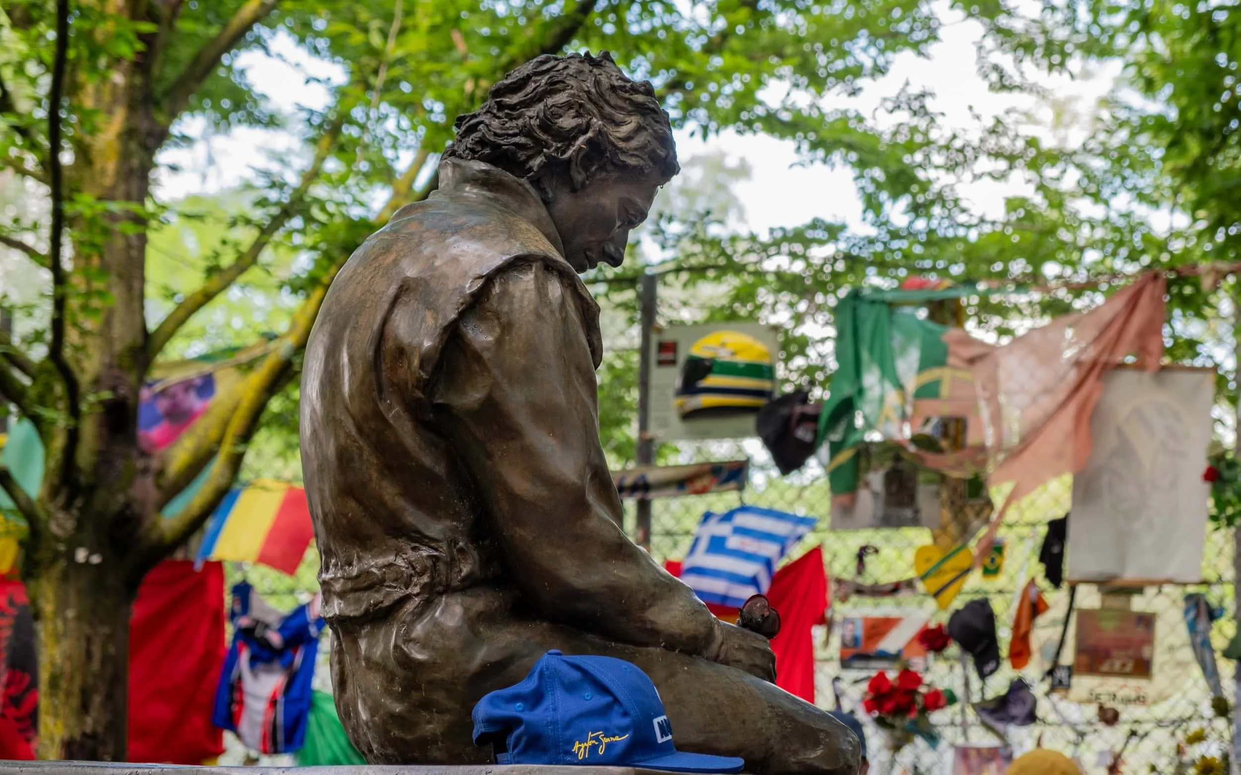 Ayrton Senna's Memorial with tribute messages and flags on the background.