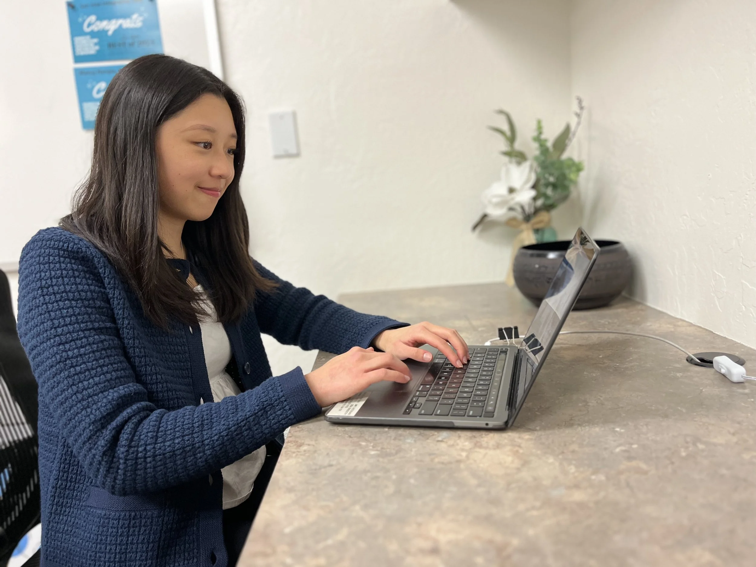 Melanie, MA & TMS technician, working computer