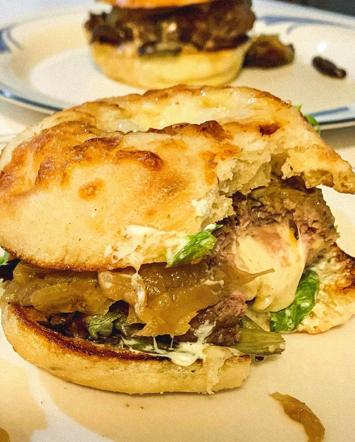 #BurgerADayMay Day 20: &ldquo;we tried @craftycowwi for the first time!! my burger is stuffed with muenster cheese &amp; topped with grilled artichoke, caramelized onion, kale pesto aioli, harvest greens, all on a cheddar and onion bun/ bagel type br