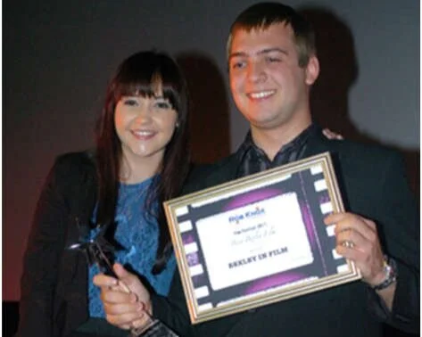 Cameron Holt receives his award from Eastenders actress Jacqueline Jossa