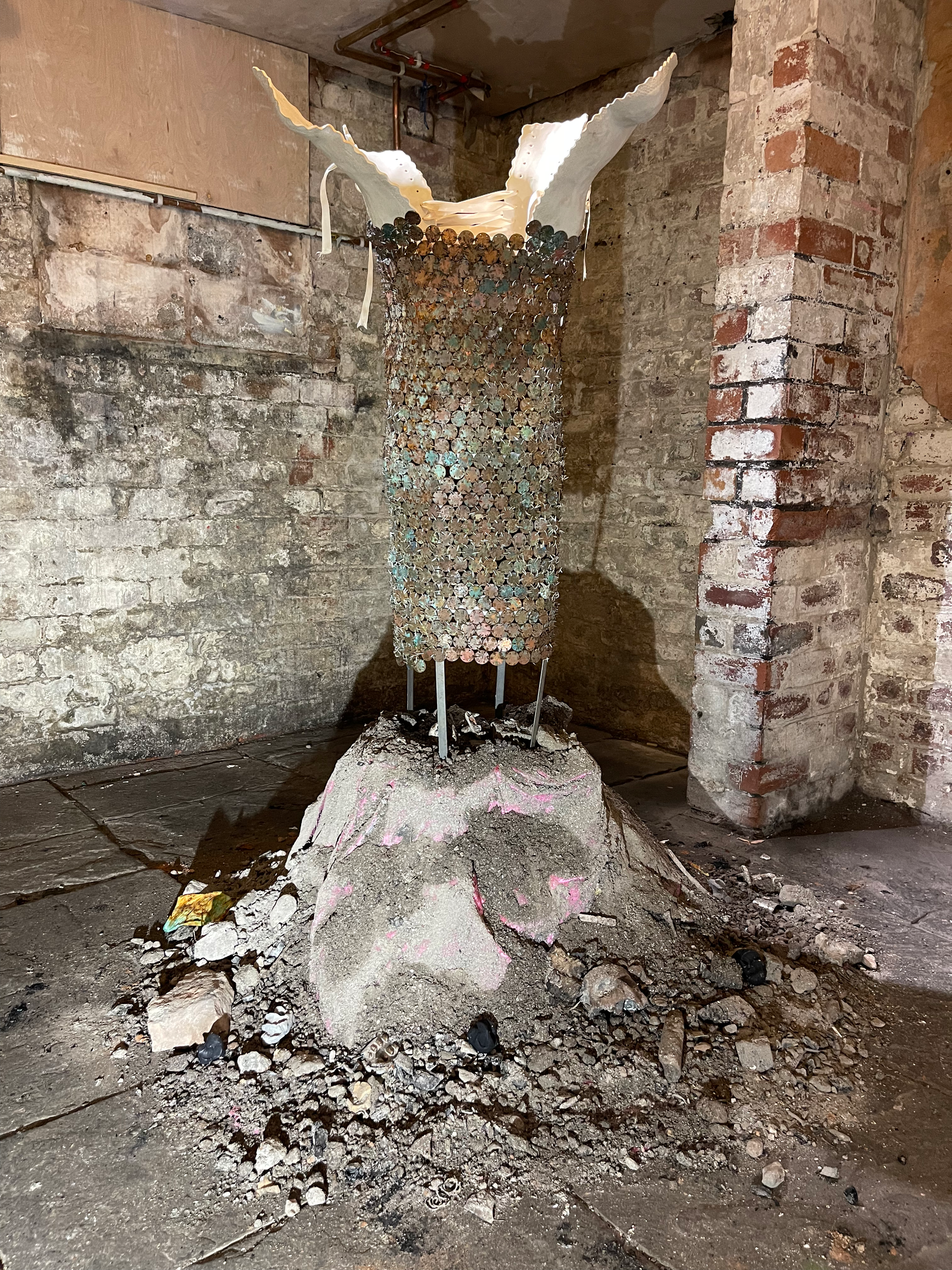 Fool me twice, but never thrice (2024) ceramic, steel, patinated copper 2 pence coins, ribbon, ash, rubble