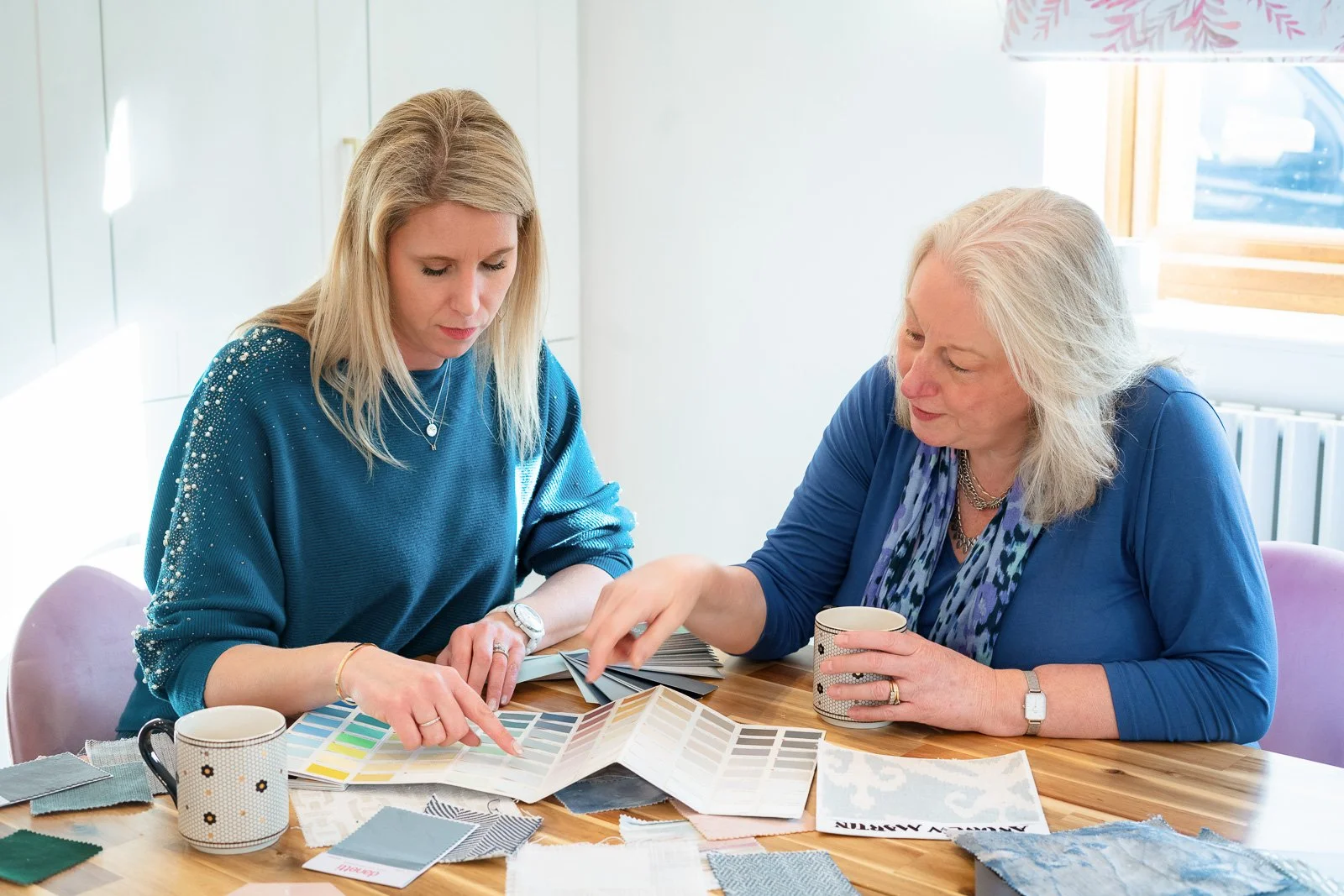 Holly Scott guiding a homeowner through colour and material choices during a Happy Home Design VIP interior design session