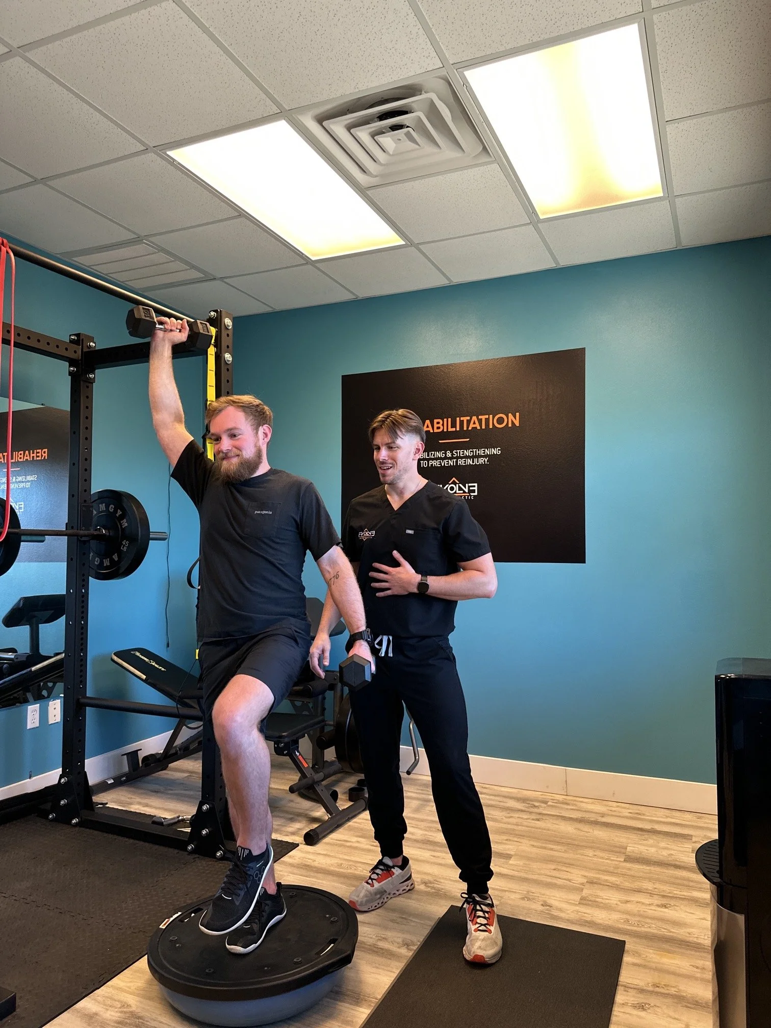 Desk worker performing guided posture rehabilitation exercises with a chiropractor in Dripping Springs