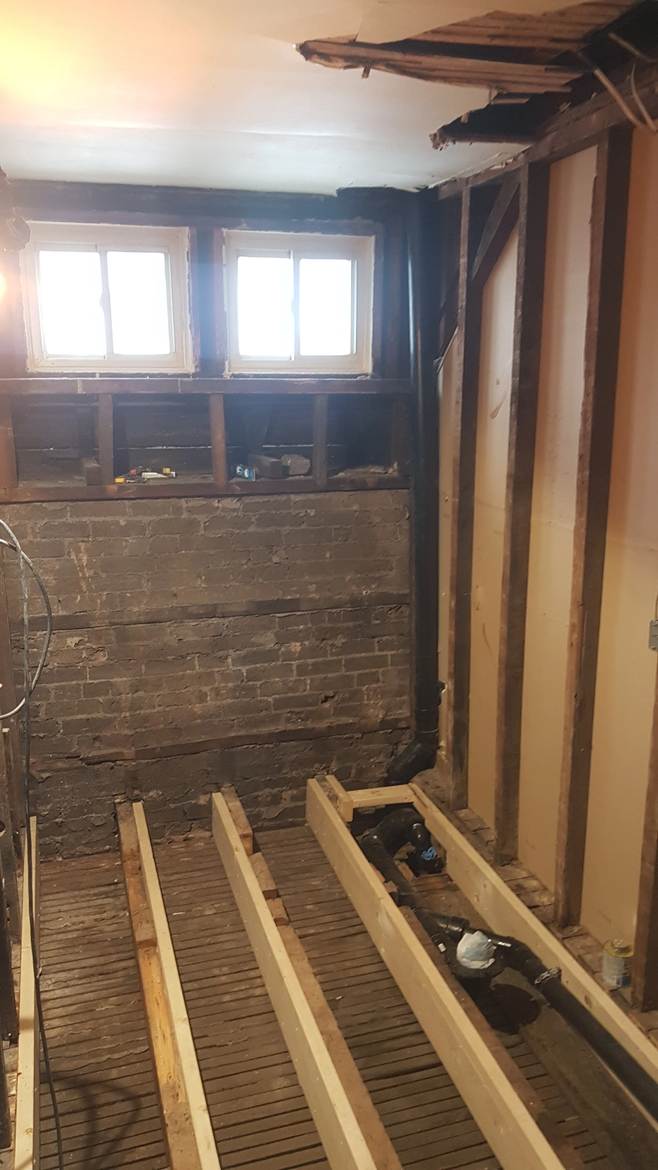 Exposed outer brick wall and flooring